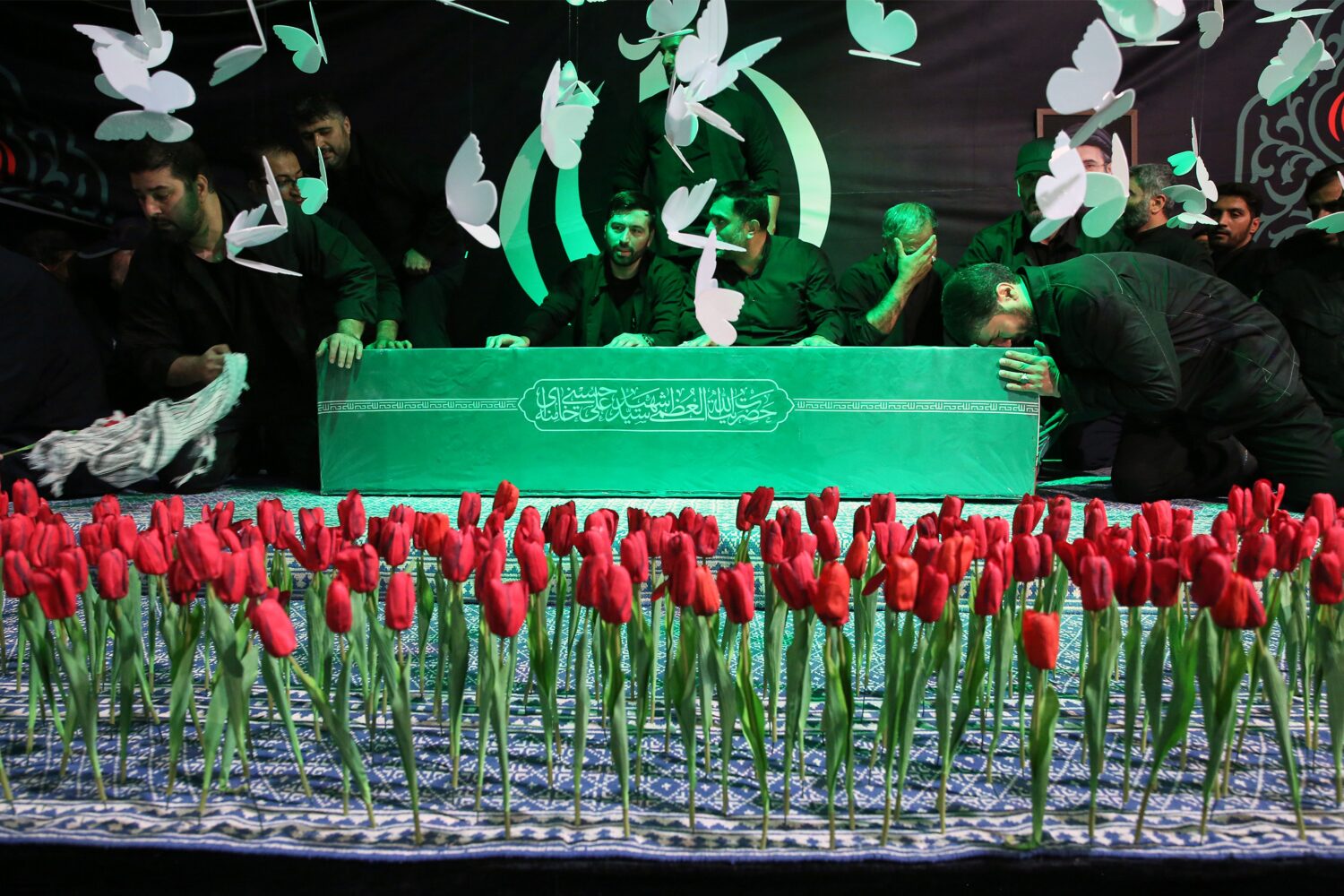 In this photo released by Iran's Supreme Leader's office, mourners gather around the coffin of Iran...