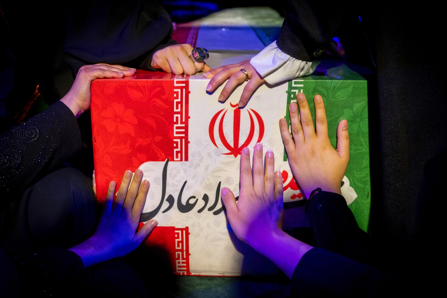 Mourners touch the coffin of Zahra Haddad-Adel, daughter of former Iranian parliament speaker Ghola...