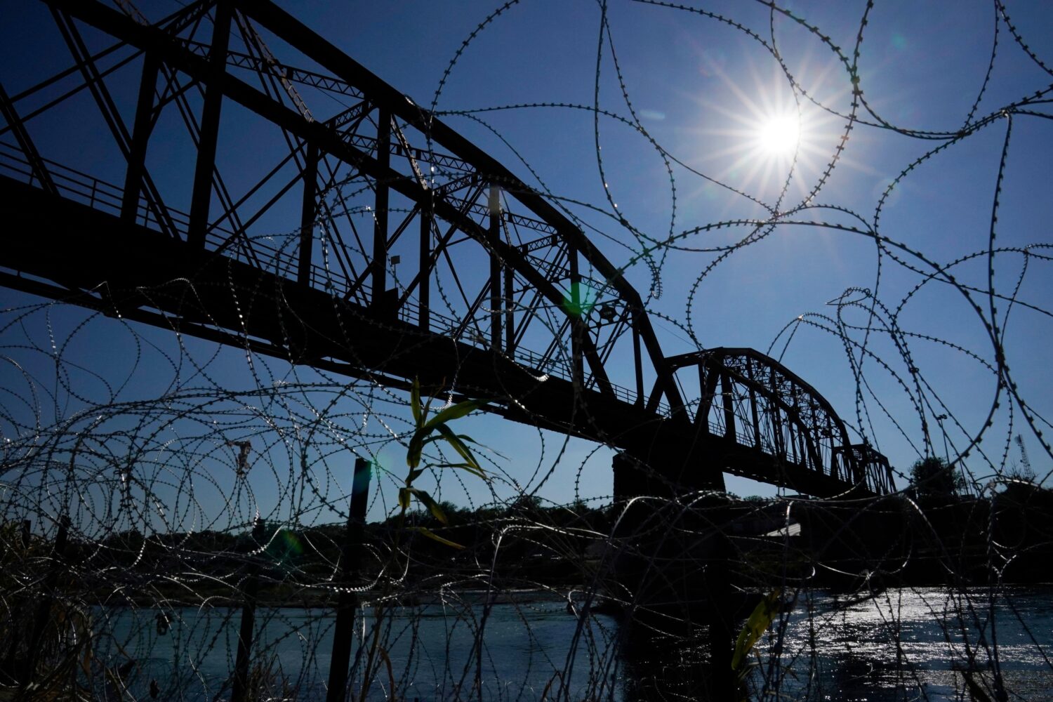 FILE - The Union Pacific International Railroad Bridge is seen behind concertina wire, Sept. 22, 20...