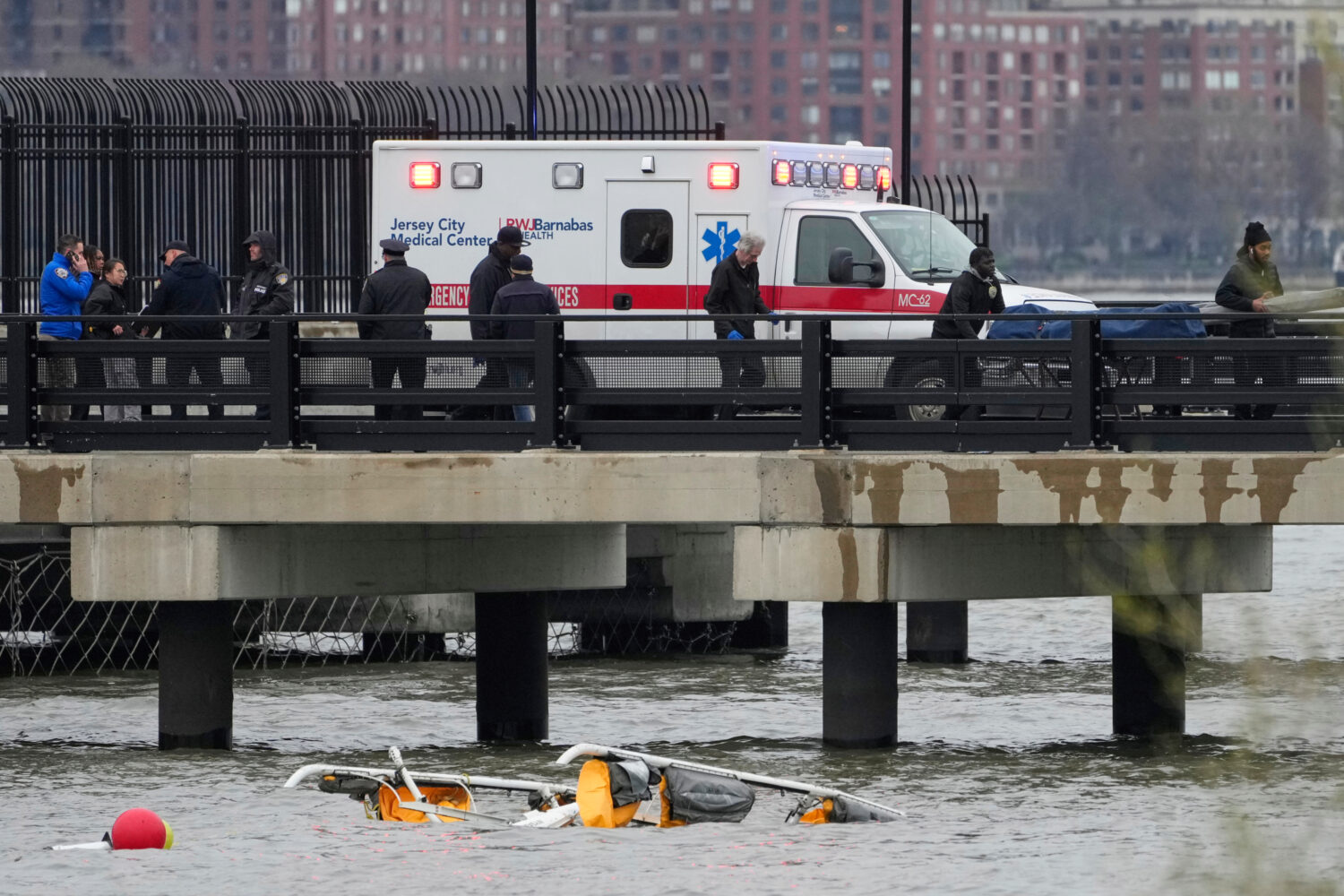 FILE - Emergency personnel respond to a helicopter crash on the Hudson River, April 10, 2025, in Je...