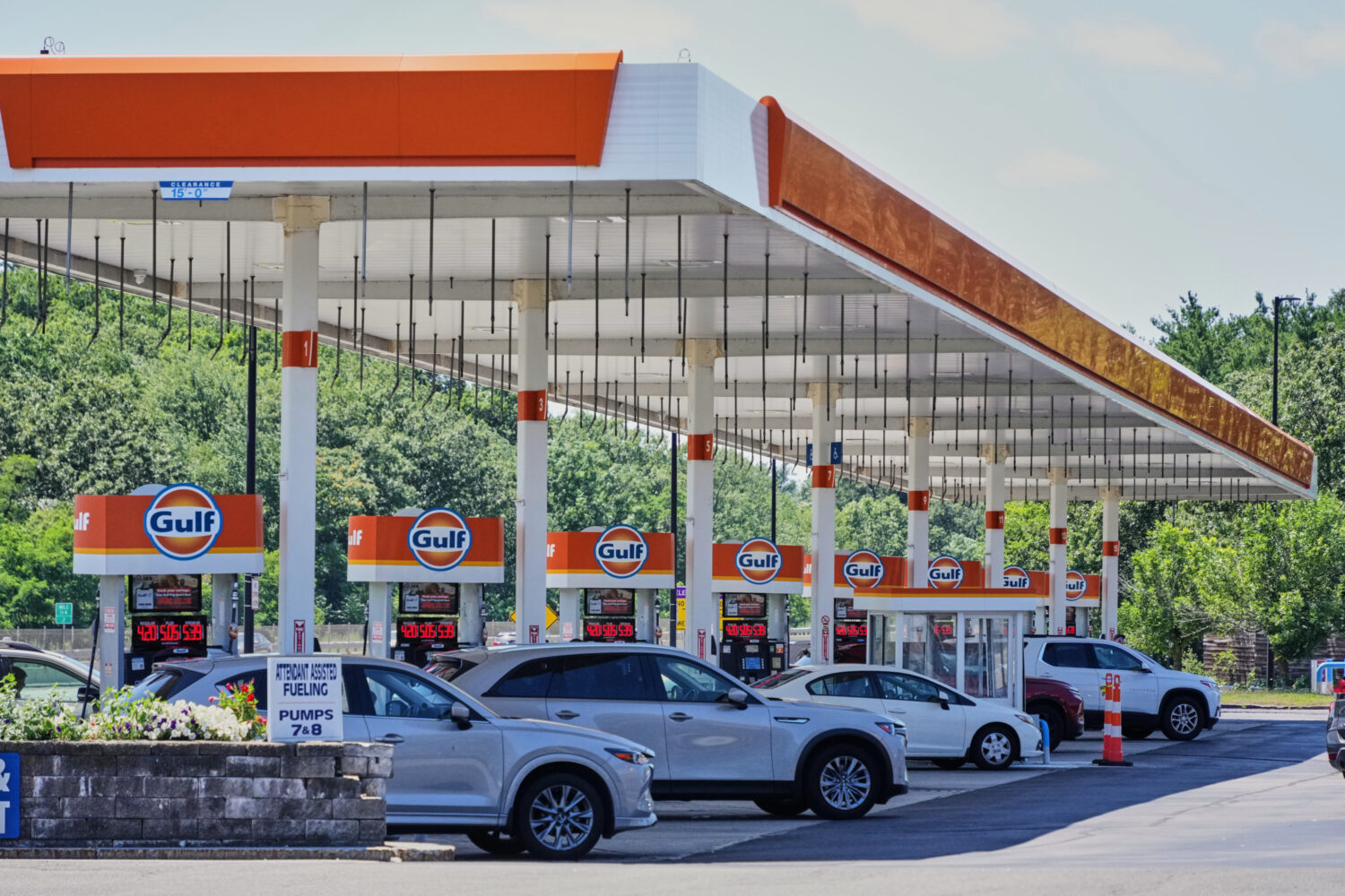 FILE - Cars line up at the pumps of a Gulf Oil station on the Massachusetts Turnpike near Boston, S...