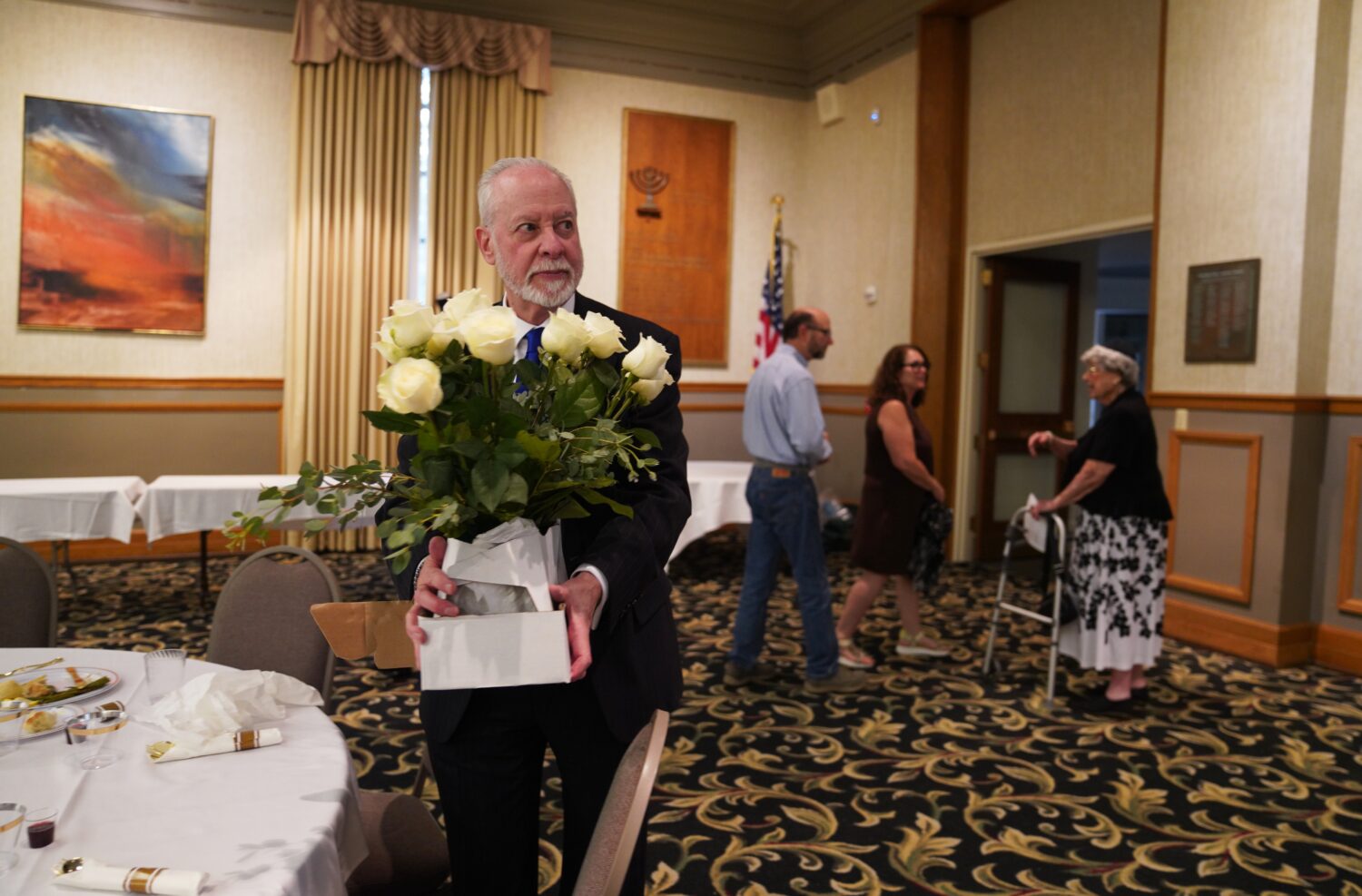 Rabbi Jeffrey Myers of the Tree of Life Congregation holds a bouquet of flowers while at his retire...