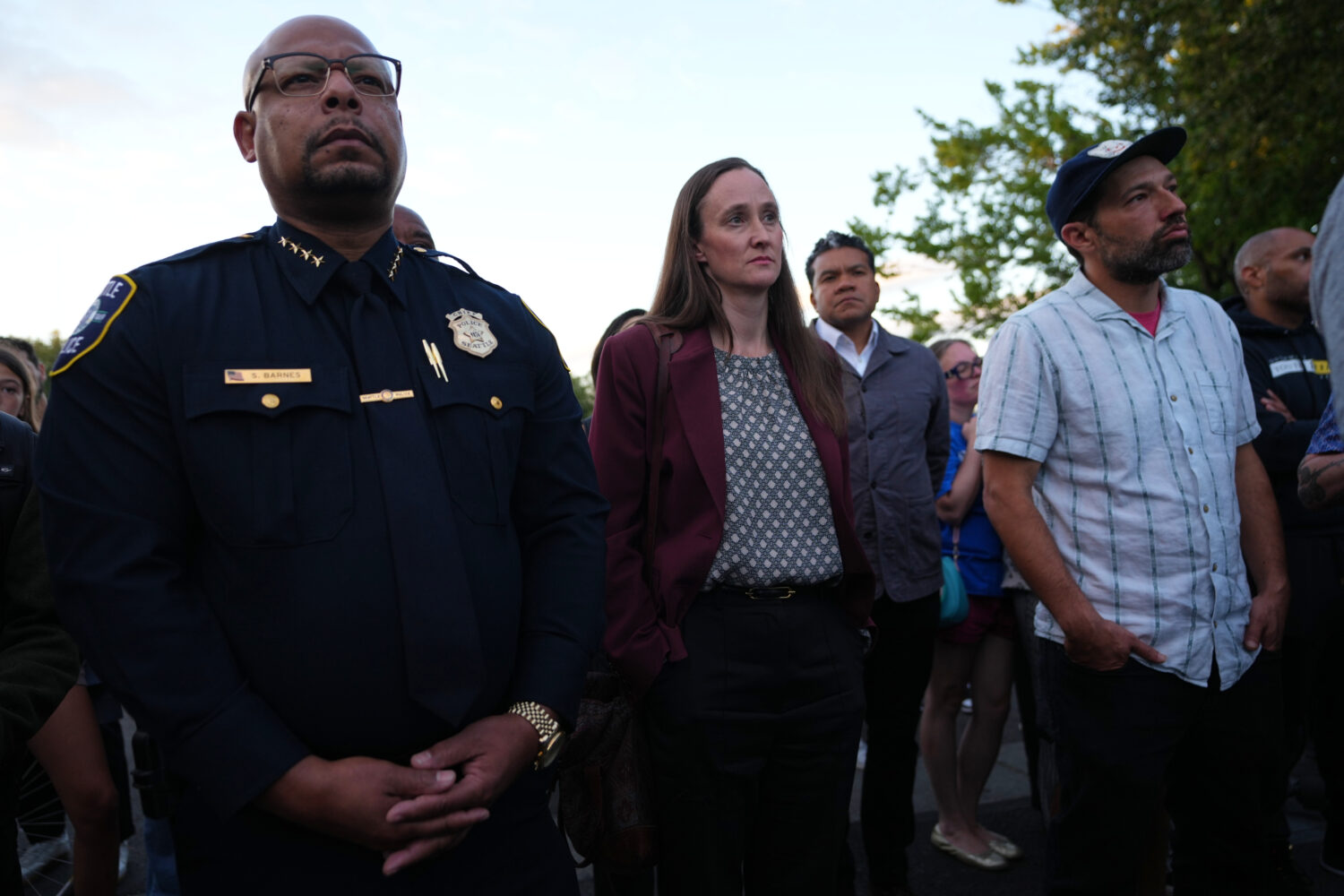 Seattle Mayor Katie Wilson, center, and Seattle Police Chief Shon Barnes, left, attend the vigil fo...