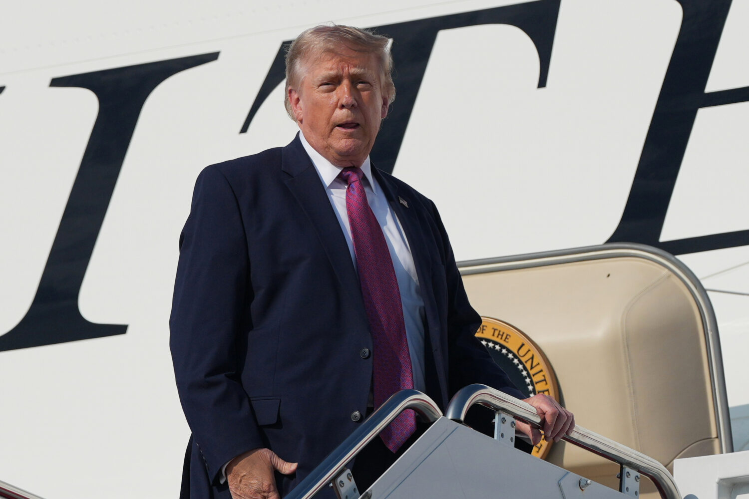 President Donald Trump boards Air Force One, Friday, July 3, 2026, at Joint Base Andrews, Md. , for...