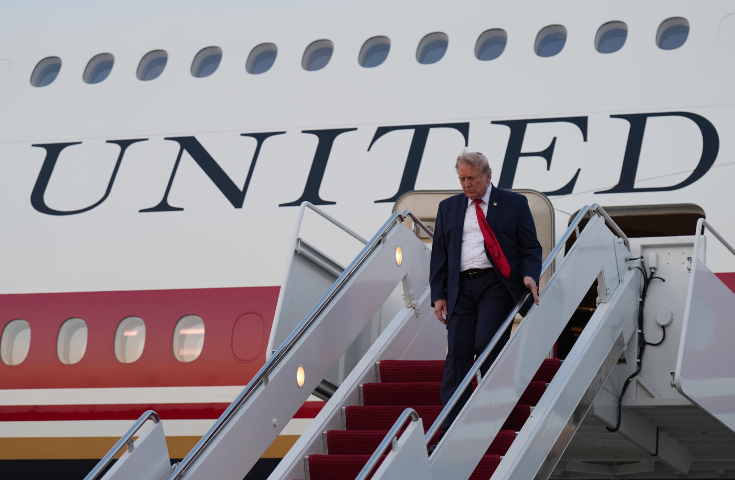 President Donald Trump exits Air Force One at Joint Base Andrews, Md., after attending the World Cu...