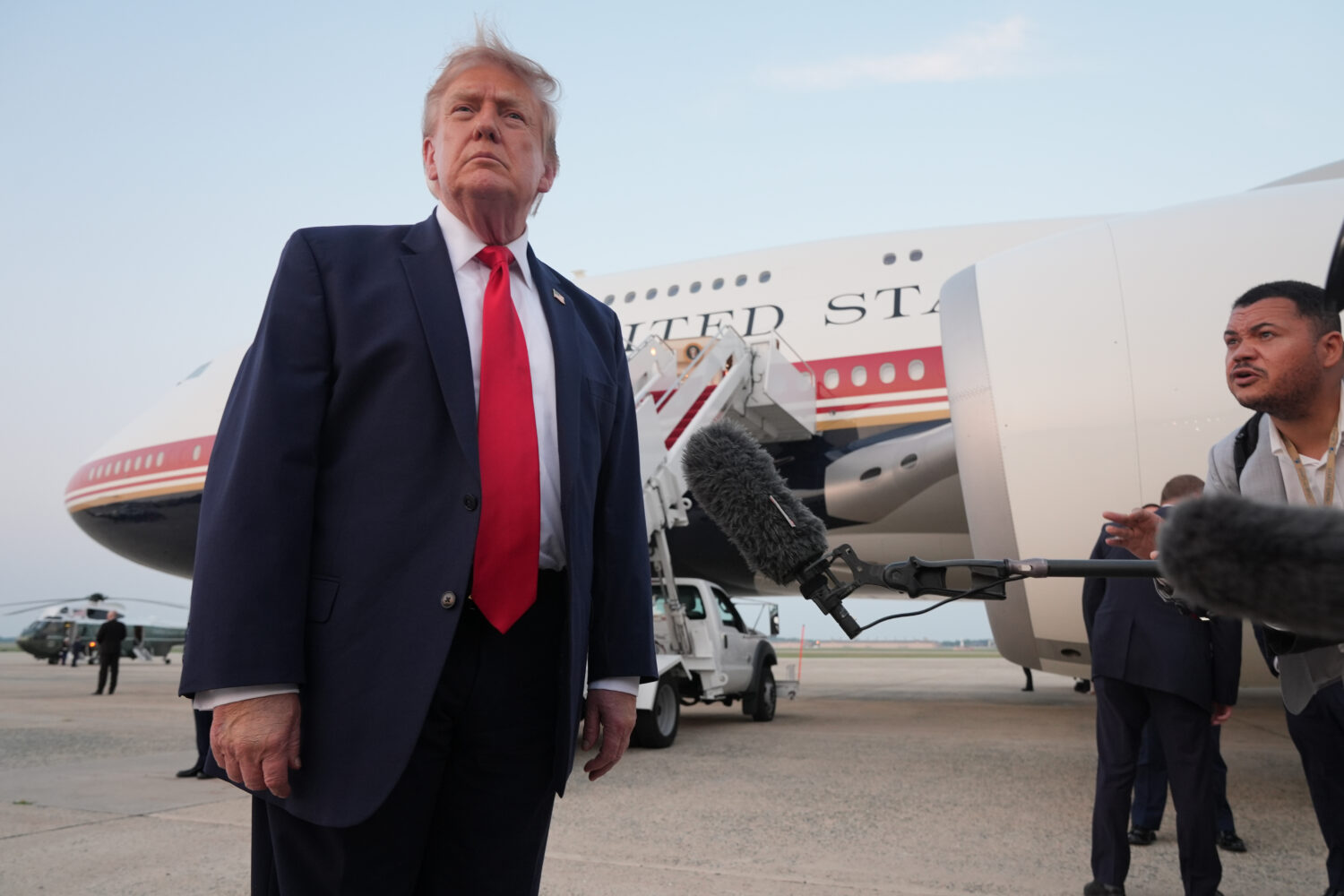 President Donald Trump speaks to reporters as he exits Air Force One at Joint Base Andrews, Md., af...