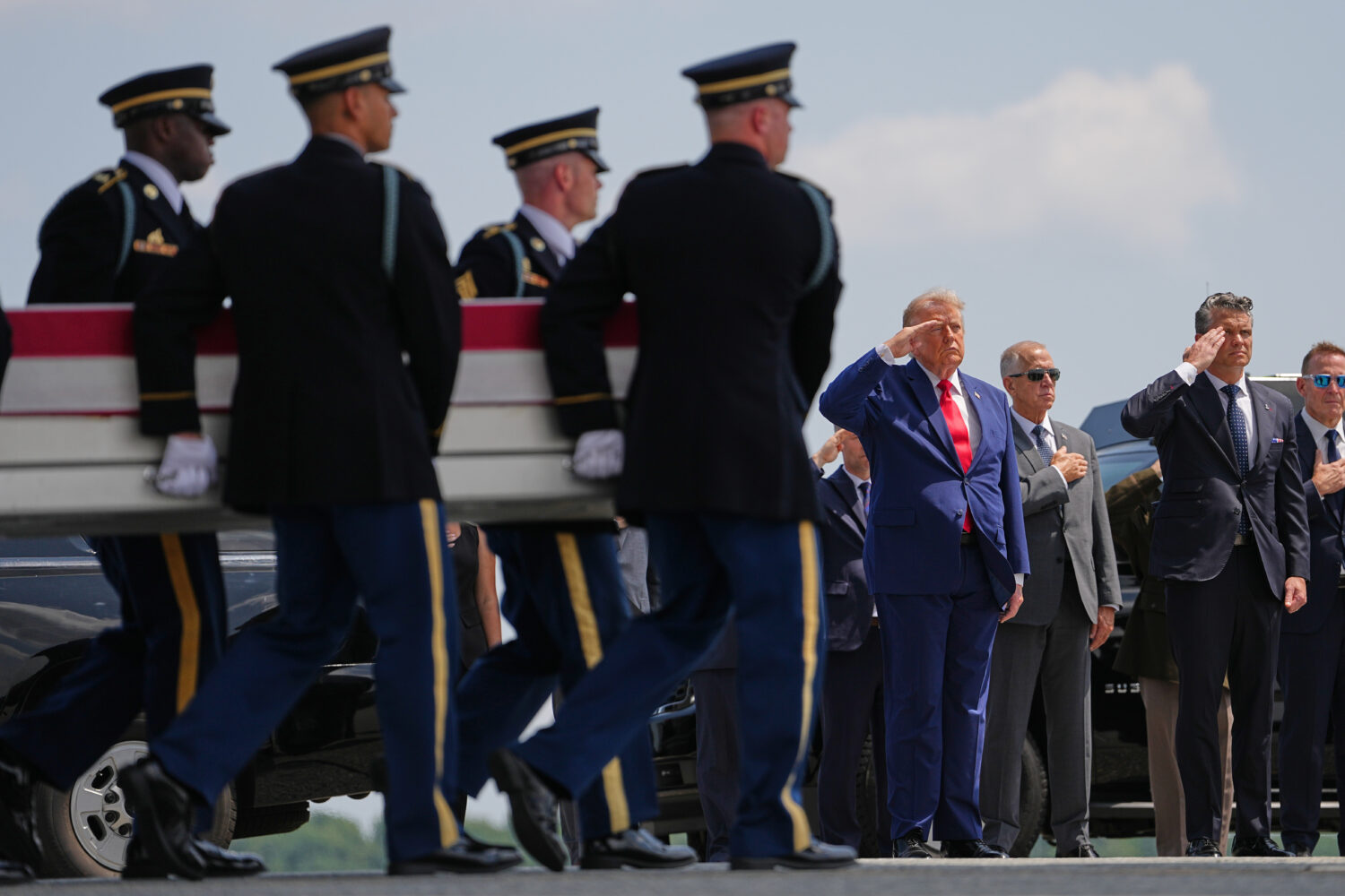 President Donald Trump and Secretary of Defense Pete Hegseth, salute as a U.S. Army carry team move...
