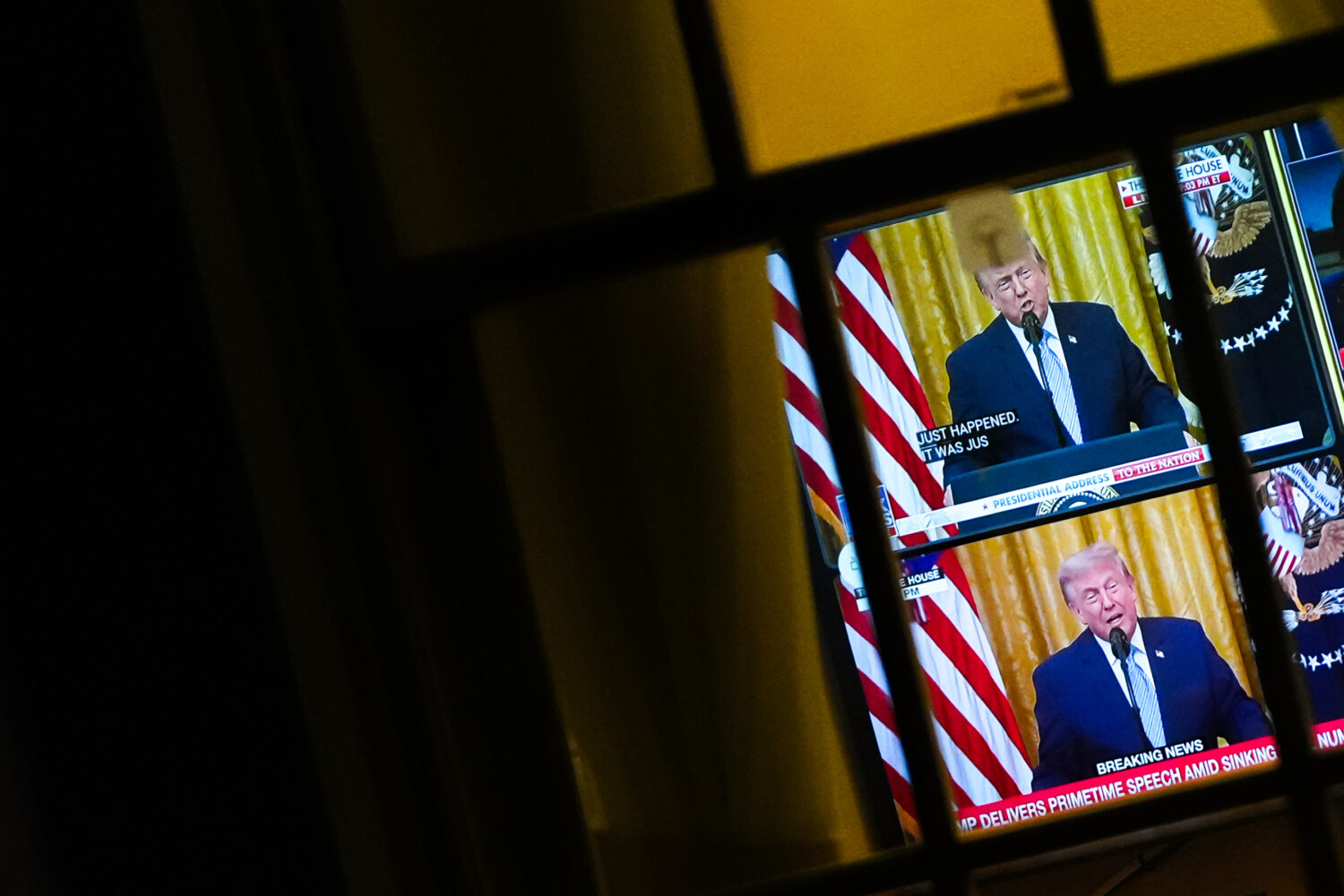 President Donald Trump is seen speaking from the East Room on a television in the West Wing of the ...
