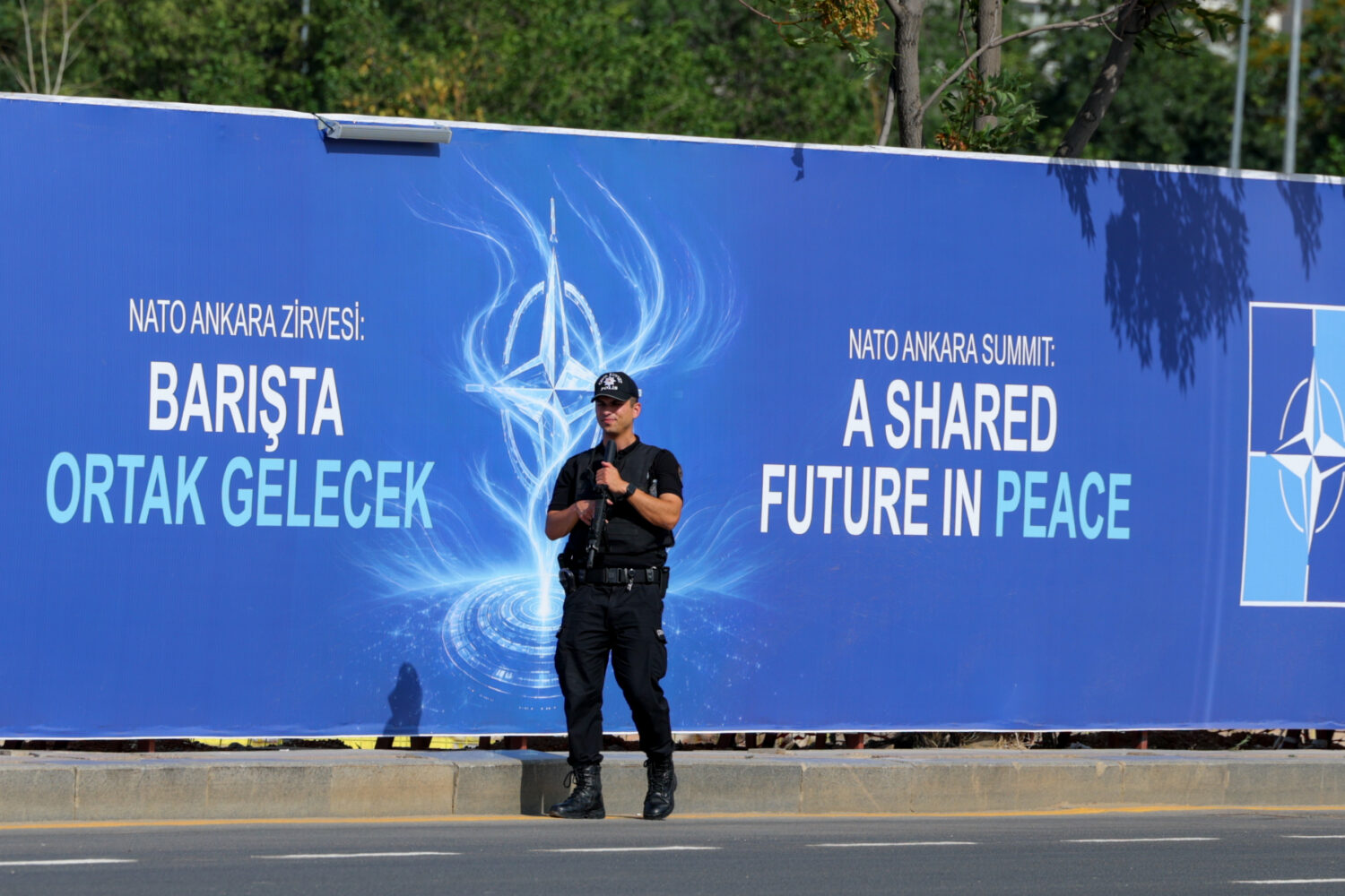 Police patrol in front of a banner ahead of the NATO Summit in Ankara, Turkey, Sunday, July 5, 2026...