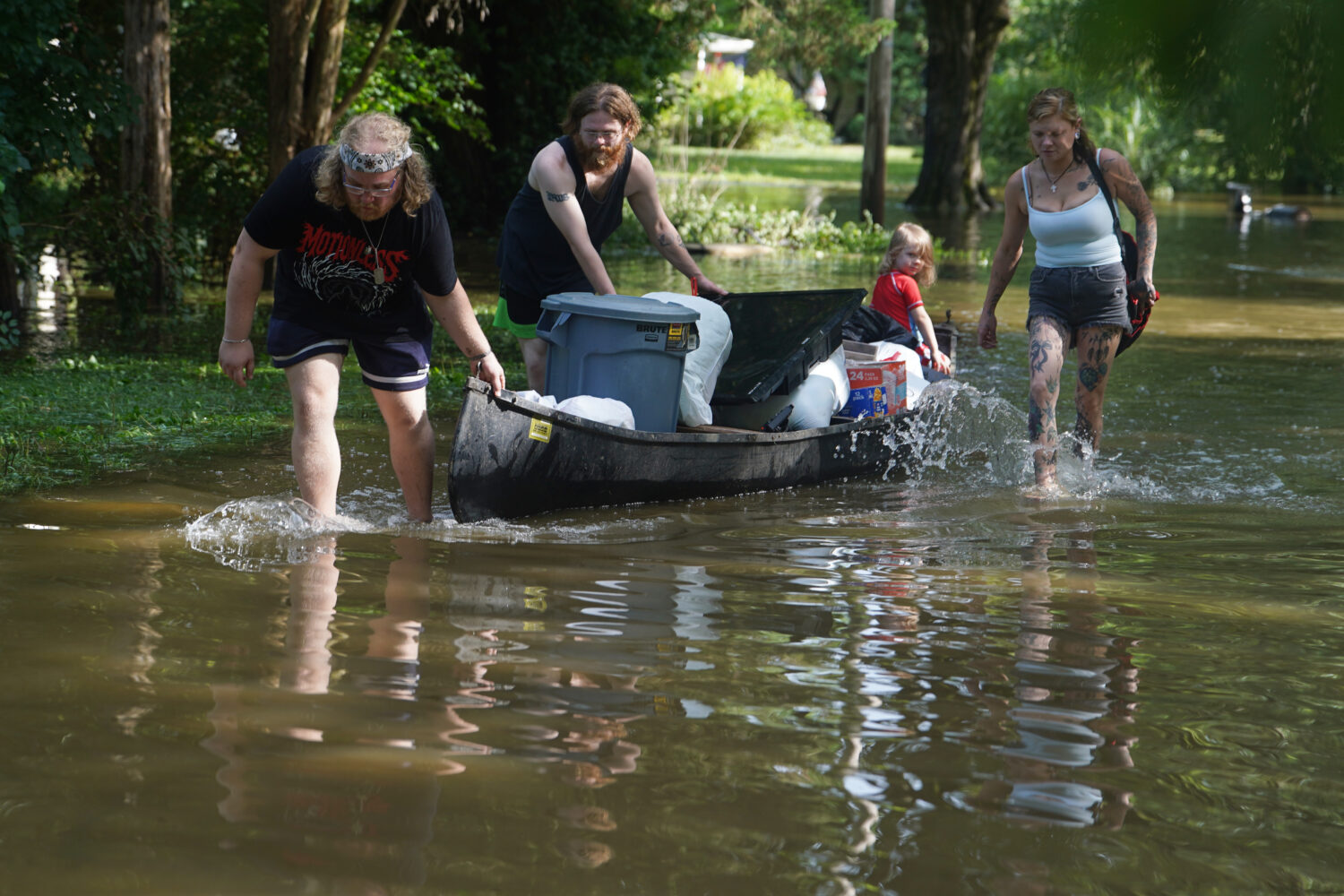 Scott Conrad, left, Joseph Workman, second from left, Ronan Carey, in the boat, and Kesley Patterso...