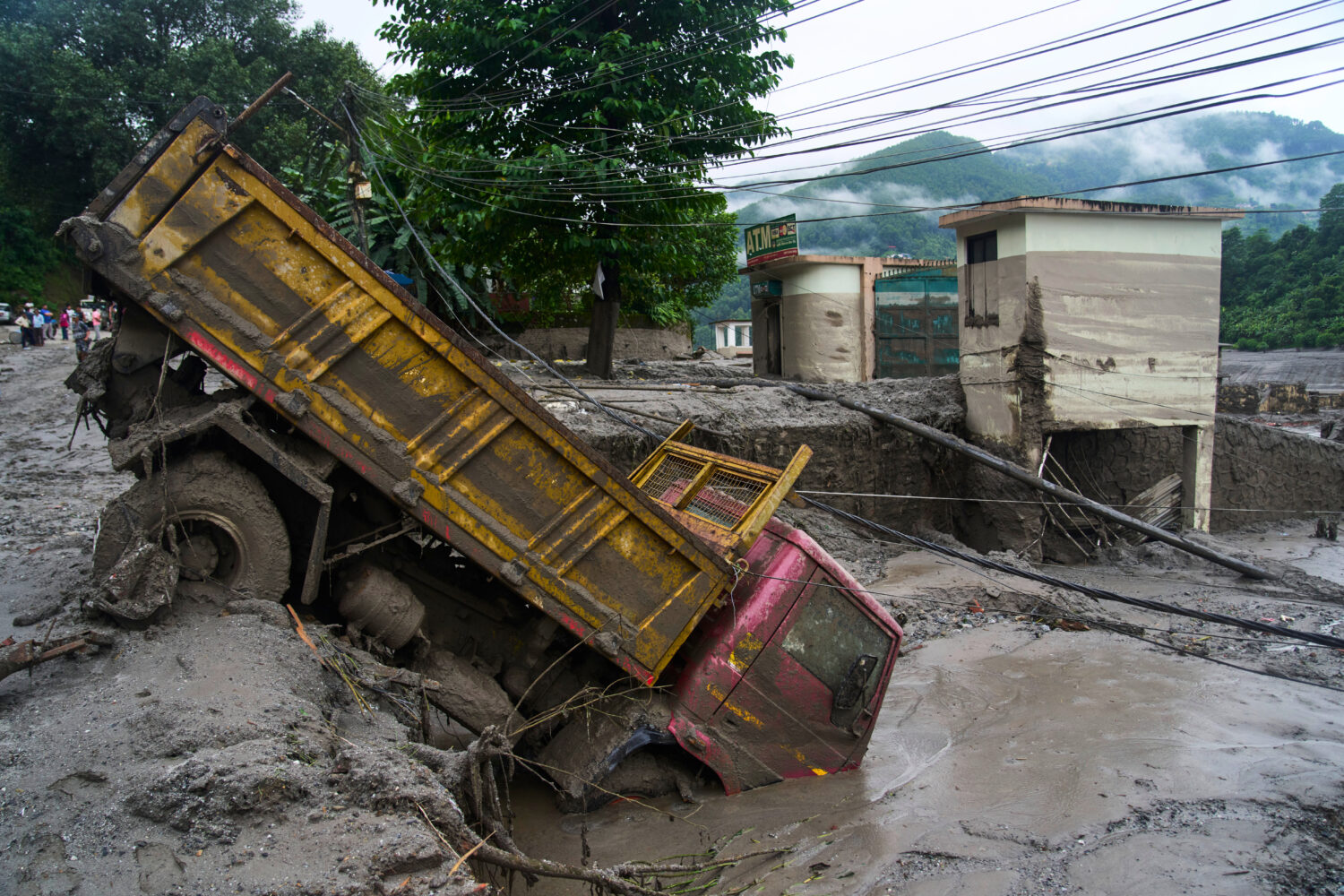 A vehicle is seen in the aftermath of flash floods in Devighat in the Nuwakot district in Nepal, Th...