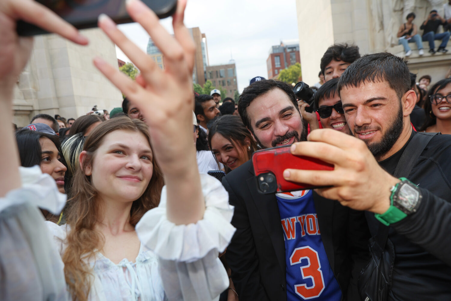 Amadeo Fusca, center, winner of the Mayor Zohran Mamdani look-alike contest, takes selfies with the...