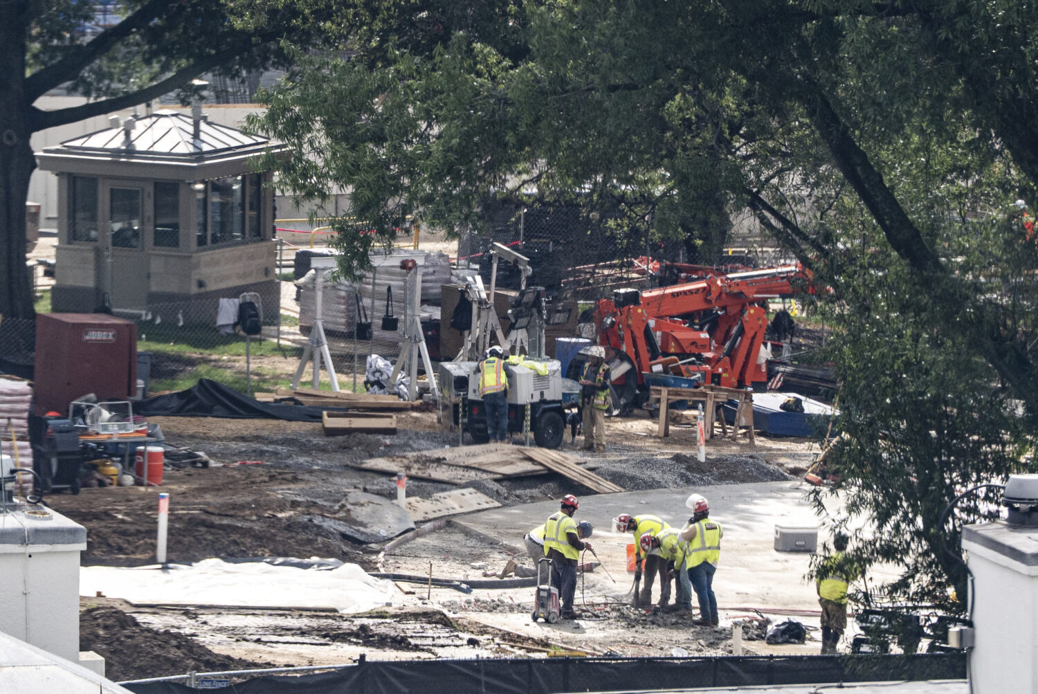 Workers use a jackhammer on the helipad on the South Lawn of the White House, Wednesday, Aug. 5, 20...