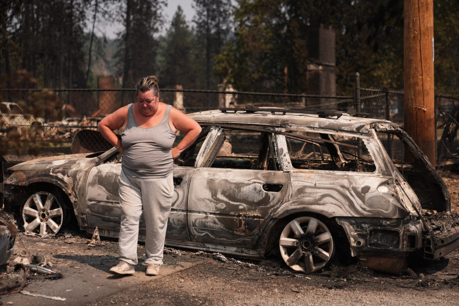 Michelle Angstrom reacts to her burned down home and property after a wildfire hit the northwest pa...