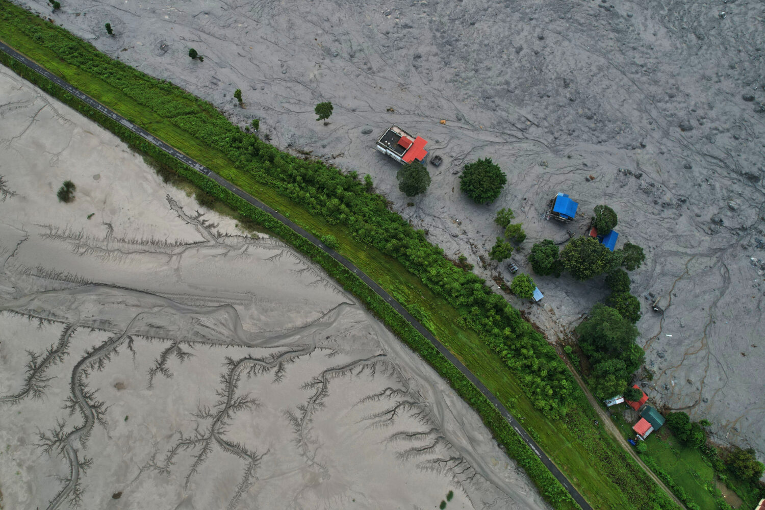 A drone view shows a major section of Pasang Lhamu highway washed away along swollen Trishuli river...