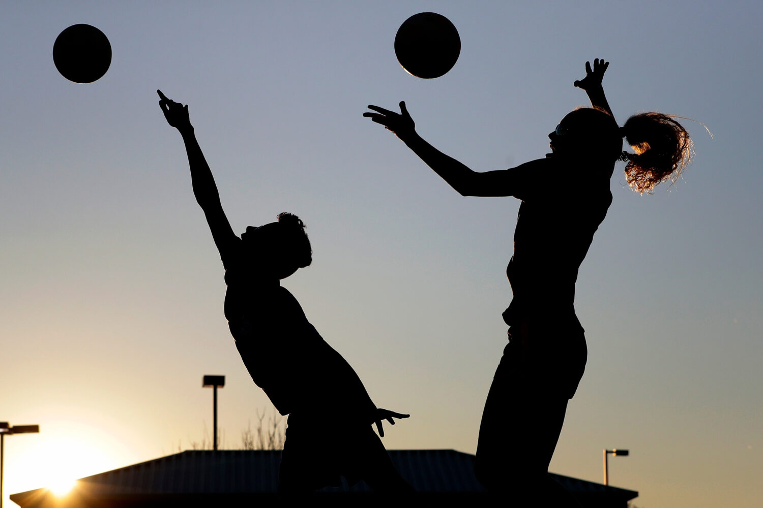FILE - Friends practice volleyball at a local park in Gilbert, Ariz., March 15, 2020. (AP Photo/Mat...