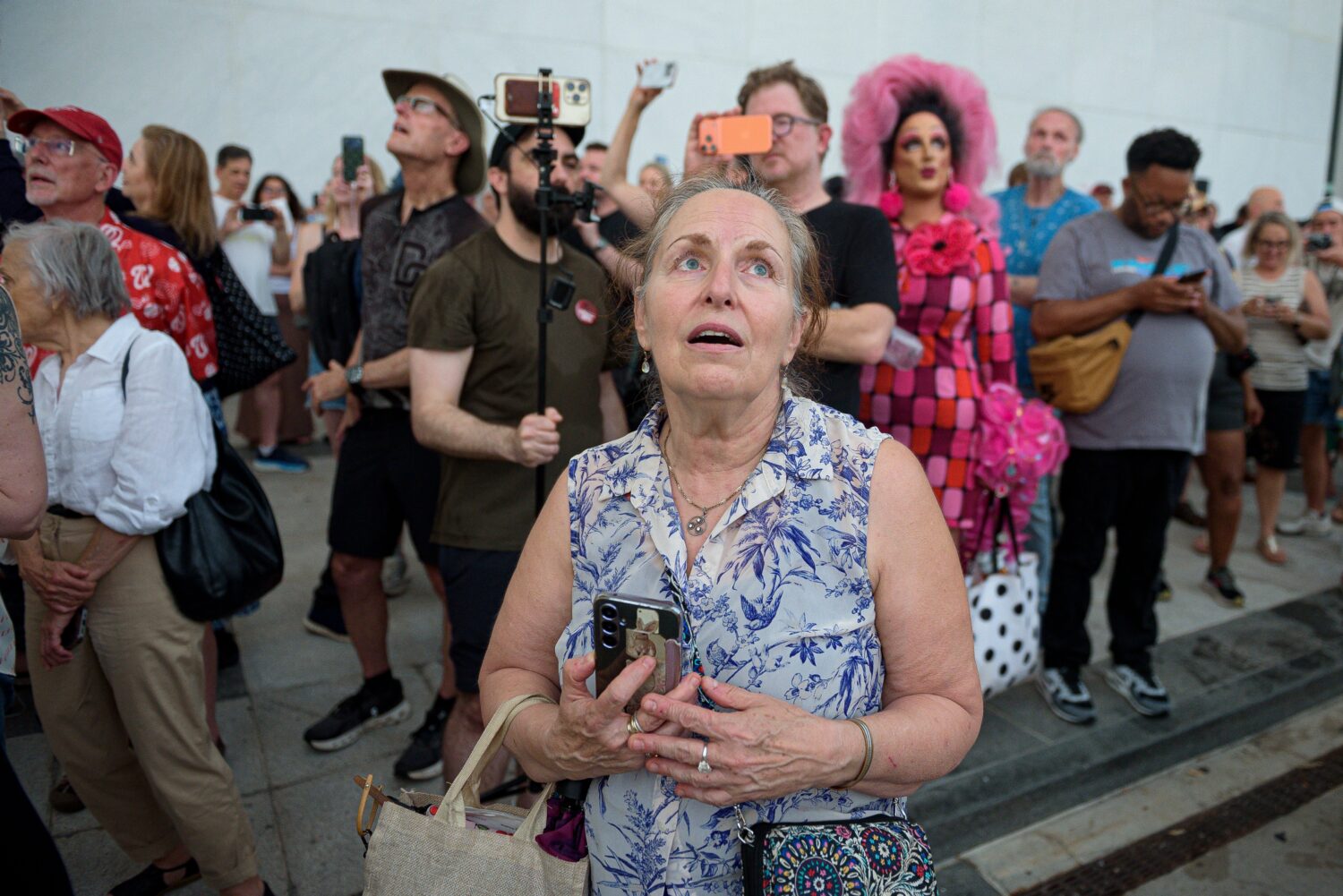 FILE - A crowd sings, "God Bless America," as they wait to watch the removal of President Donald Tr...