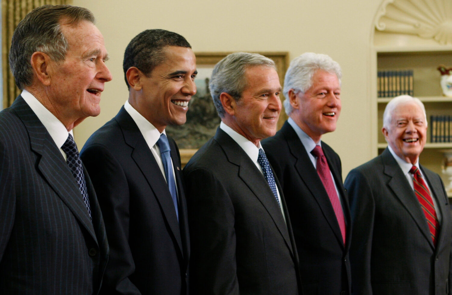 FILE - President George W. Bush, center, poses with President-elect Barack Obama, and former presid...