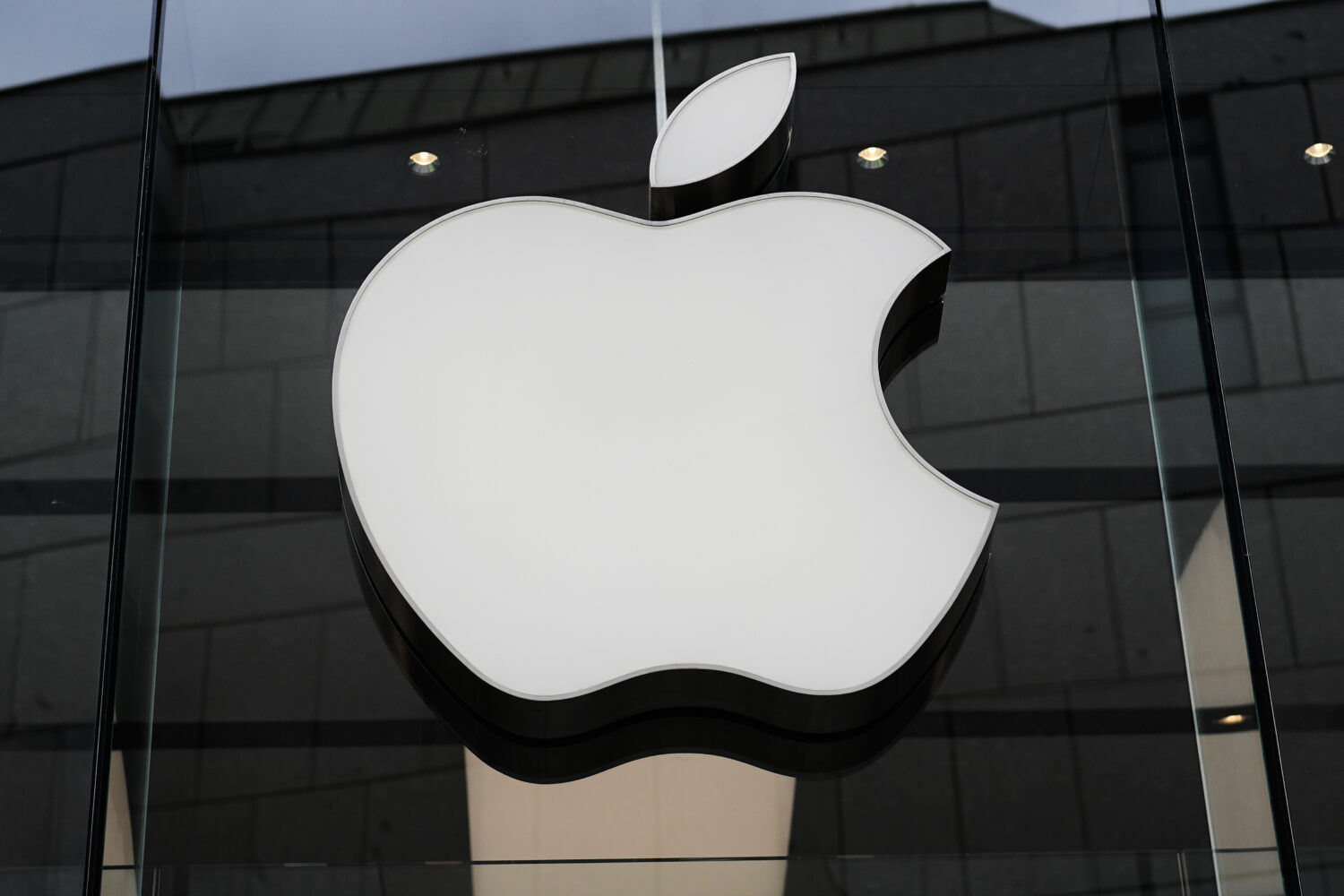 FILE - The Apple logo is illuminated at a store in Munich, Germany, April 2, 2026. (AP Photo/Matthi...