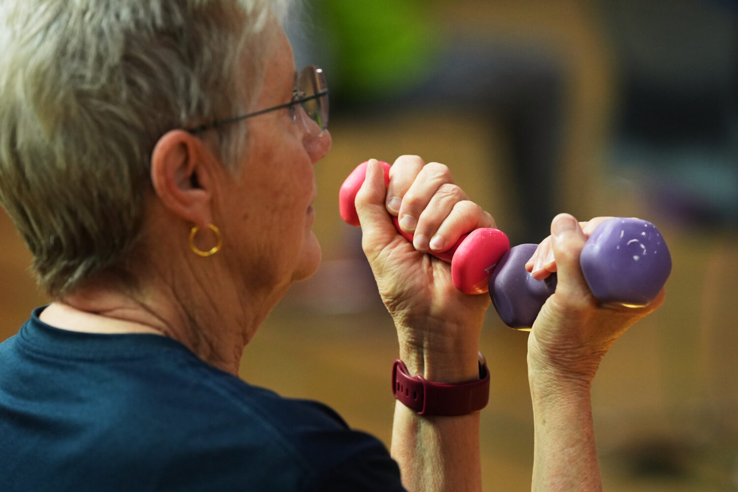 FILE - A participant uses light weights during a class for older adults at the Dale Turner Family Y...
