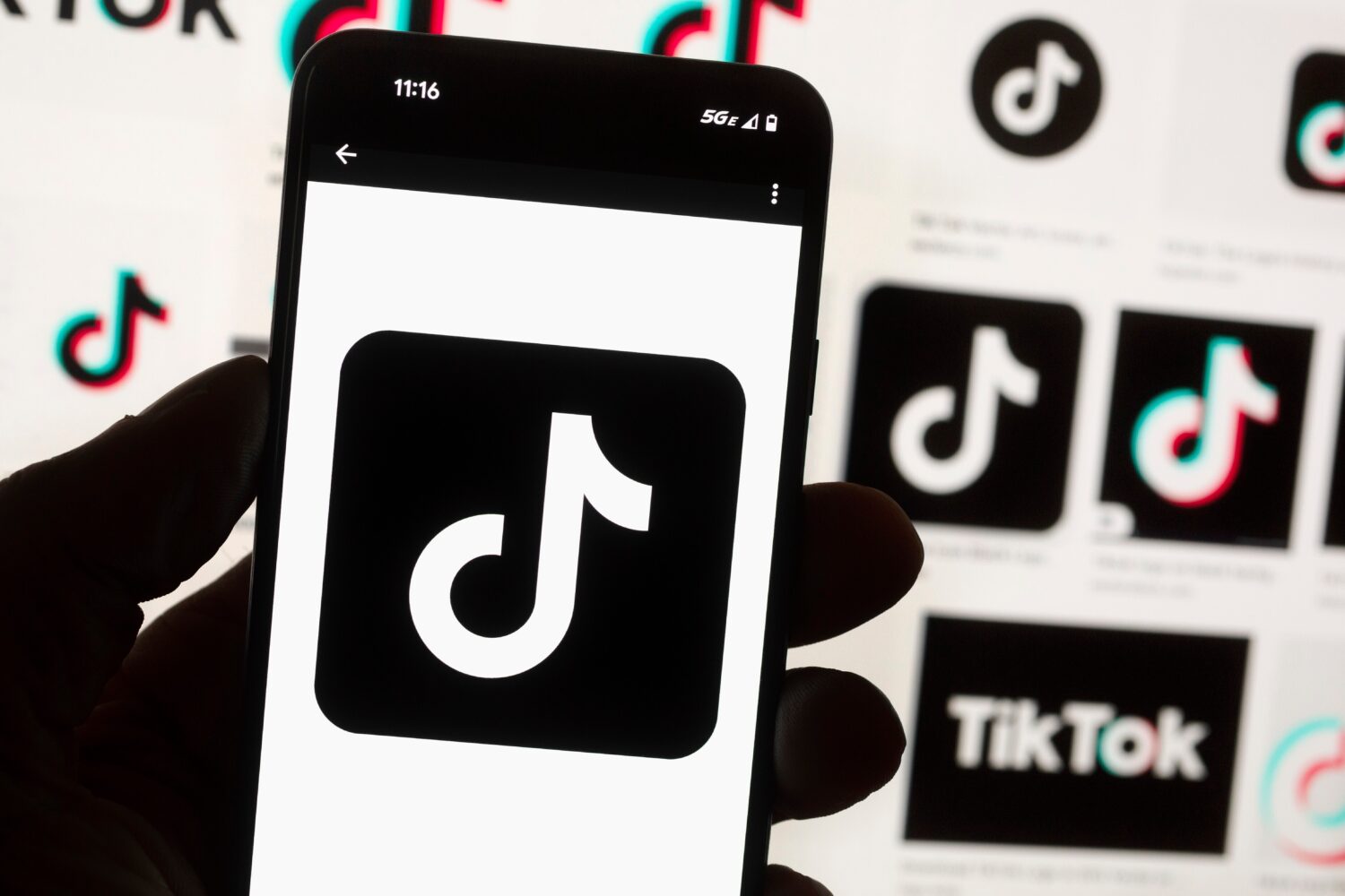 FILE - The TikTok logo is displayed on a mobile phone in front of a computer screen, Oct. 14, 2022,...