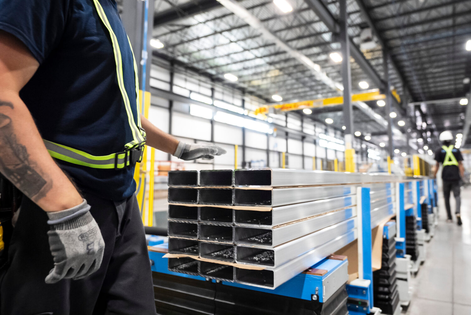 FILE - Workers prepare extruded aluminum product for packaging at Magna Aluminum Profile's fully el...