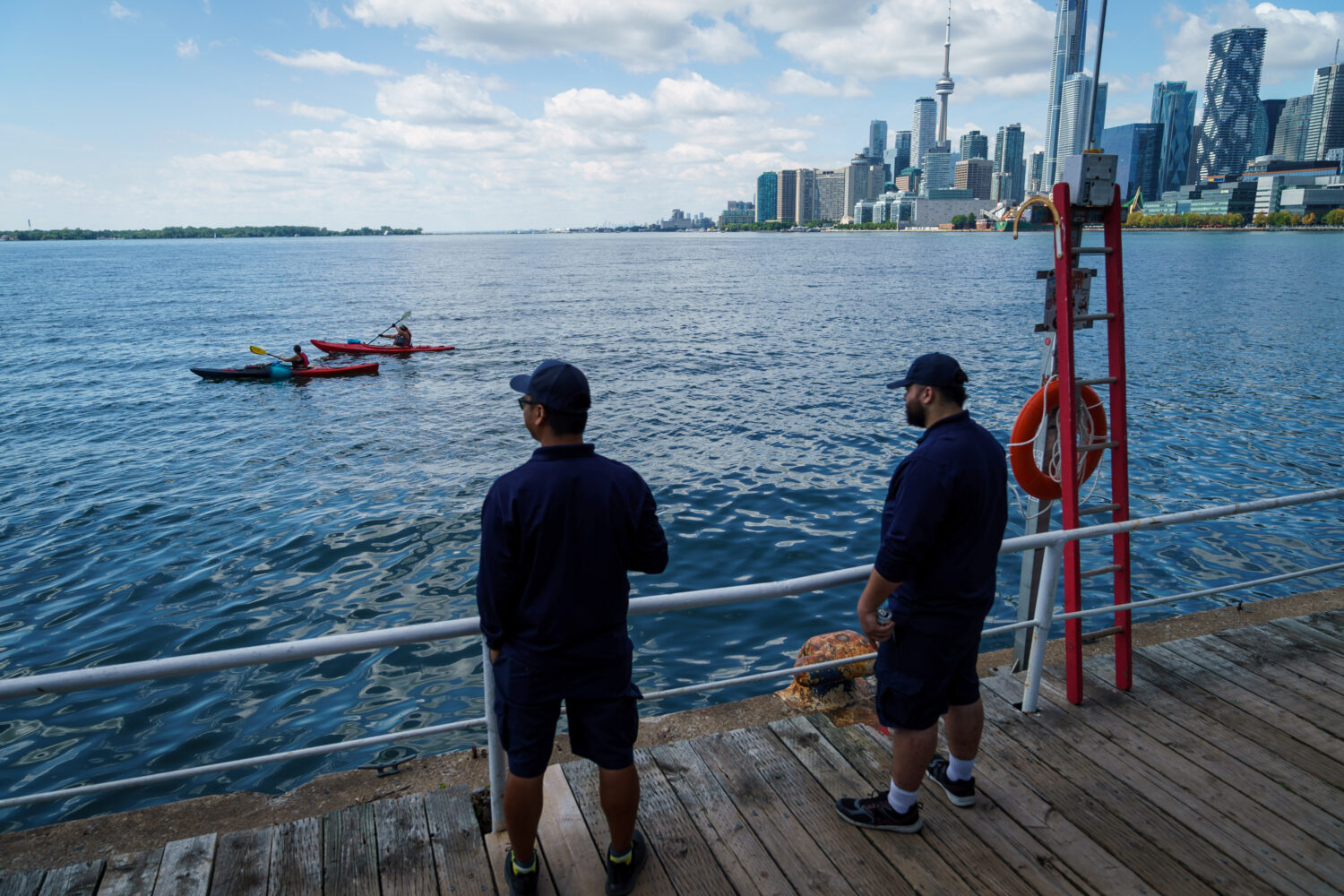 People look out across Lake Ontario from the harbor in Toronto, Tuesday, Aug. 25, 2026. (Keito Newm...