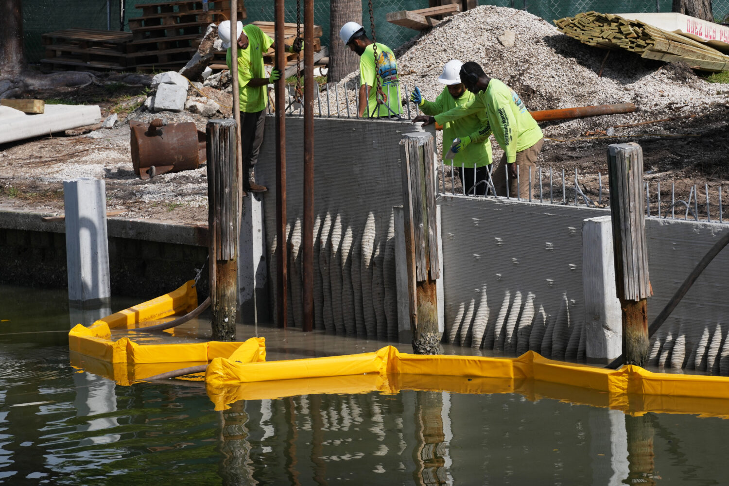 Workers install a 3D-printed living seawall manufactured by Kind Designs at the Church by the Sea, ...