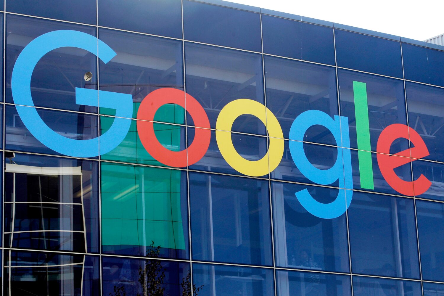 FILE - A sign is displayed on a Google building at their campus in Mountain View, Calif., Sept. 24,...