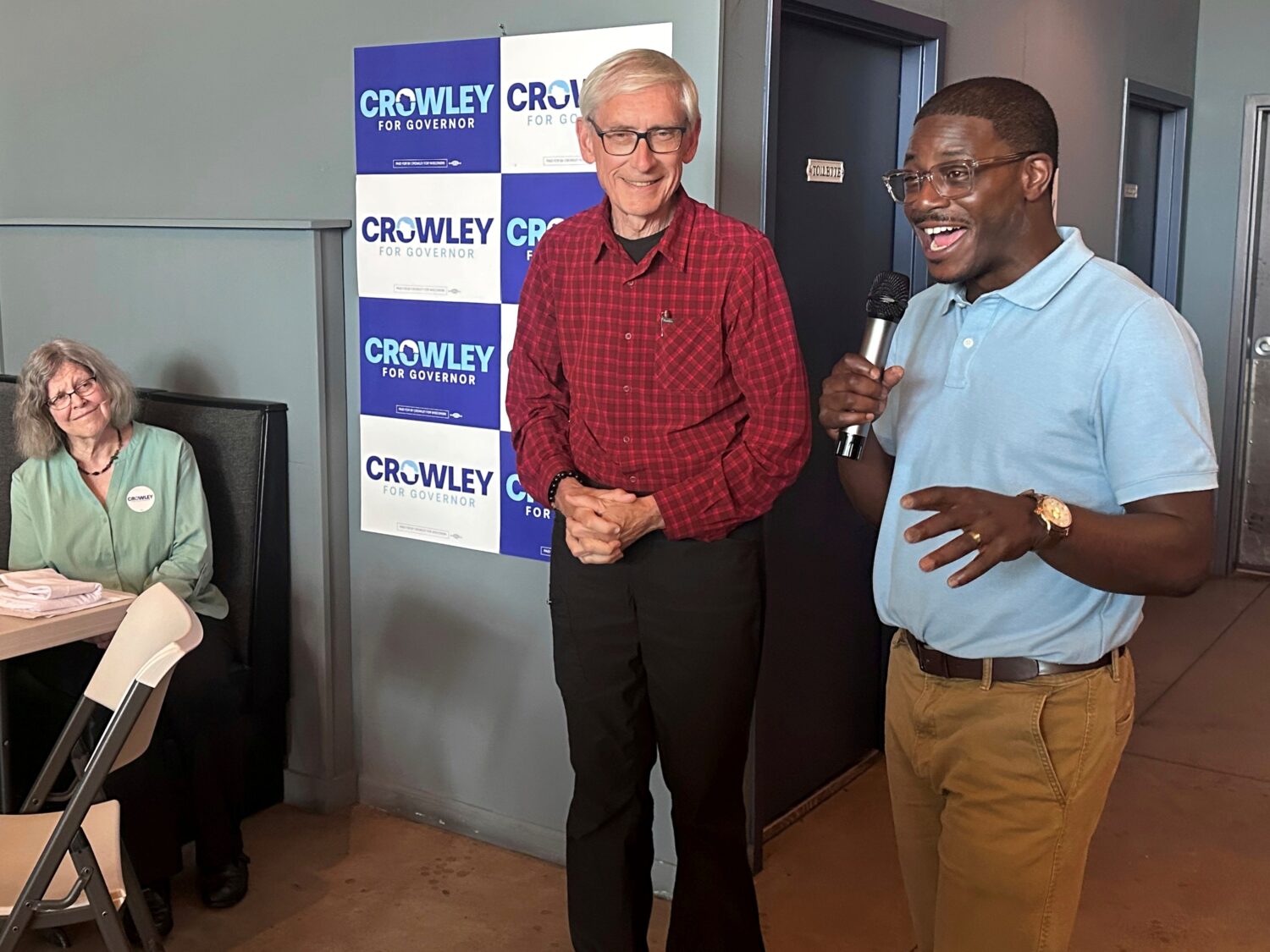 Wisconsin Gov. Tony Evers, center, campaigns with Democratic candidate for Governor David Crowley, ...