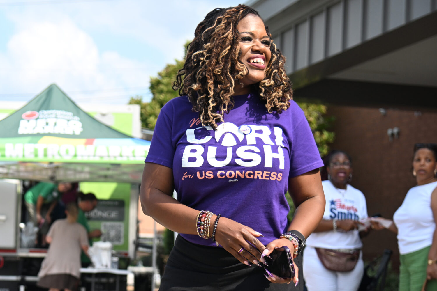 Former U.S. Rep. Cori Bush, D-Mo., greets voters during a polling location visit on primary electio...