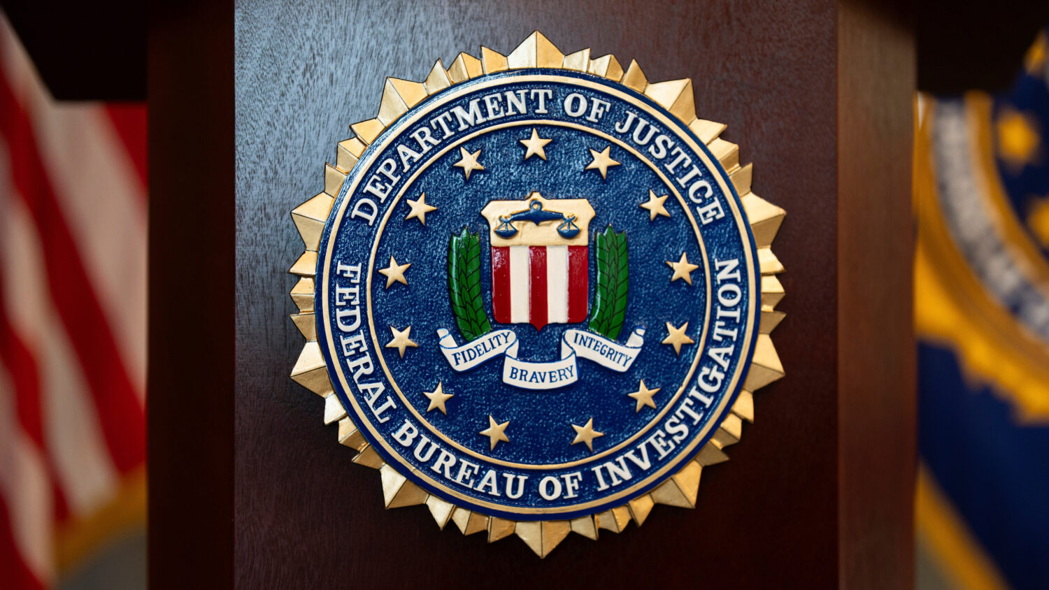 FILE - An FBI seal is displayed on a podium before a news conference at the field office in Portlan...