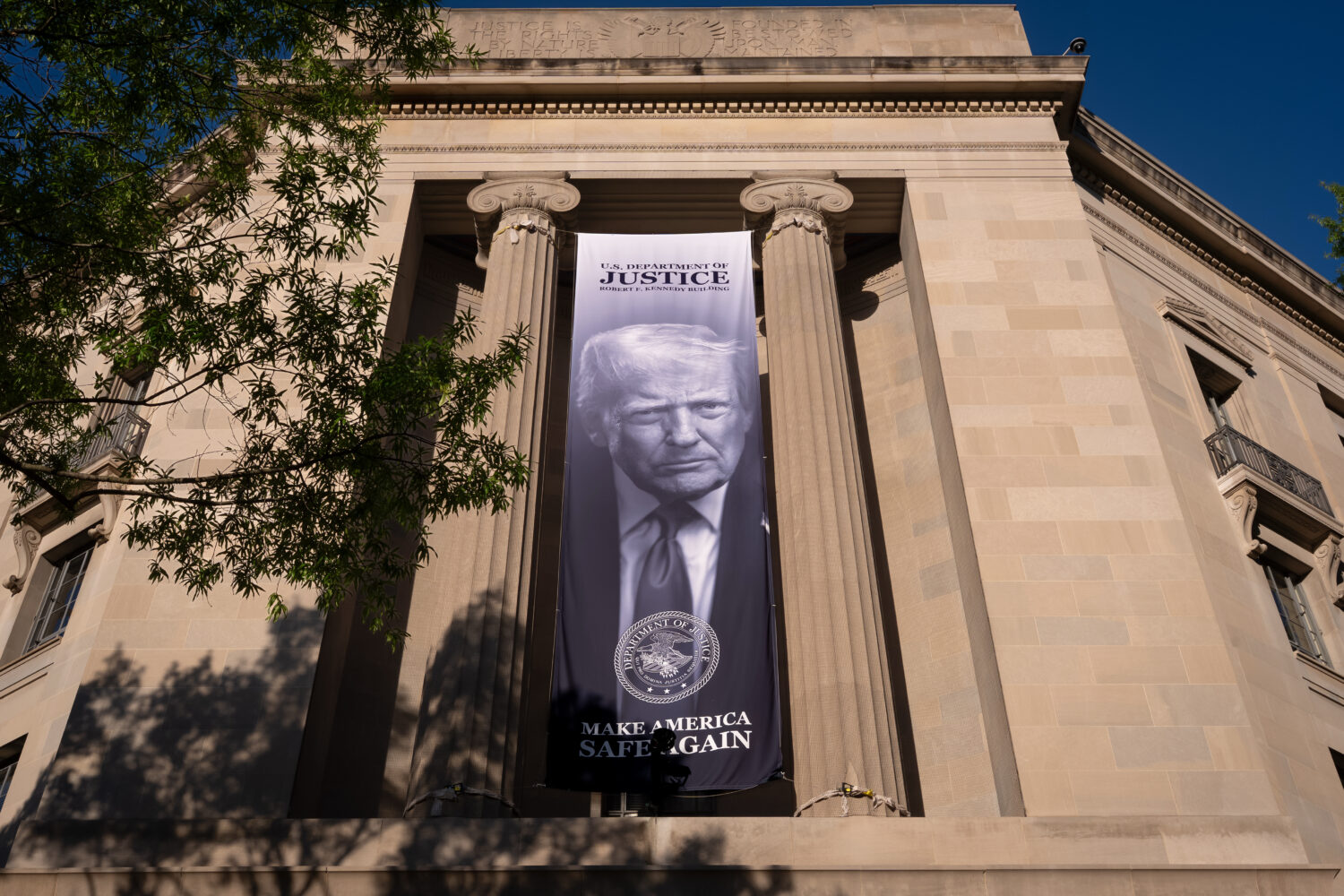 FILE - A portrait of President Donald Trump is displayed at the Justice Department building in Wash...