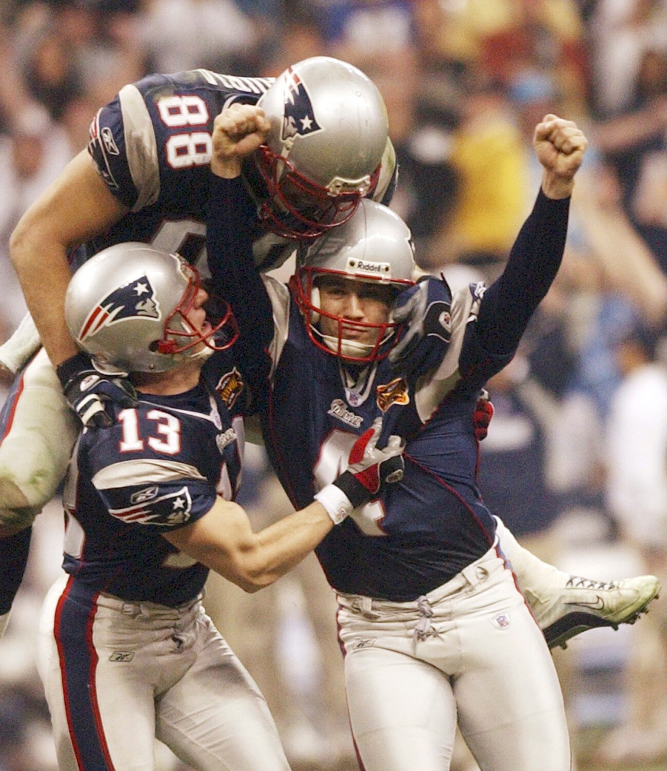FILE - New England Patriots kicker Adam Vinatieri celebrates his game-winning field goal with teamm...