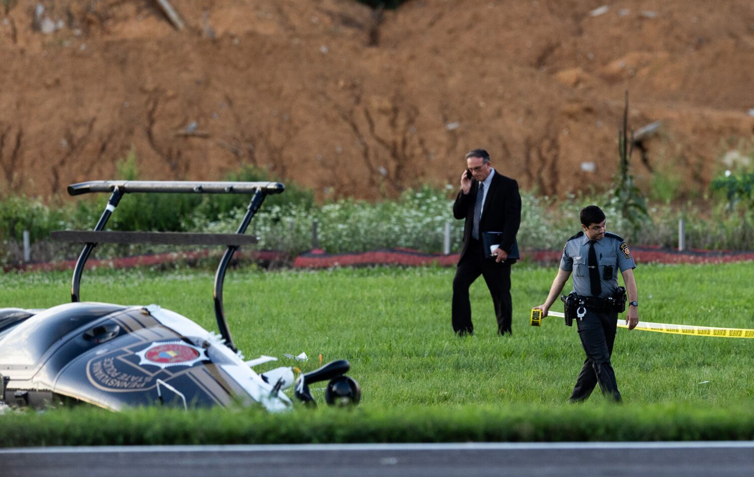 Authorities investigate a crash between a Pennsylvania State Police helicopter and a small plane at...
