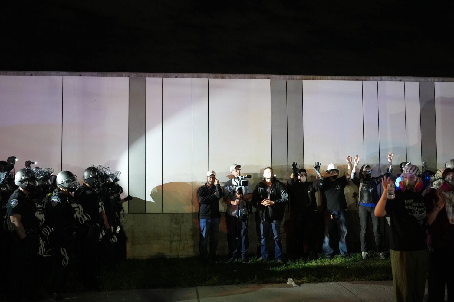 FILE - Law enforcement officers kettle protesters outside Delaney Hall detention center Sunday, May...