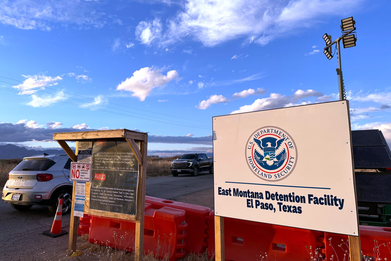 FILE - A sign marks the entrance to a series of hardened tents at the Camp East Montana immigrant d...