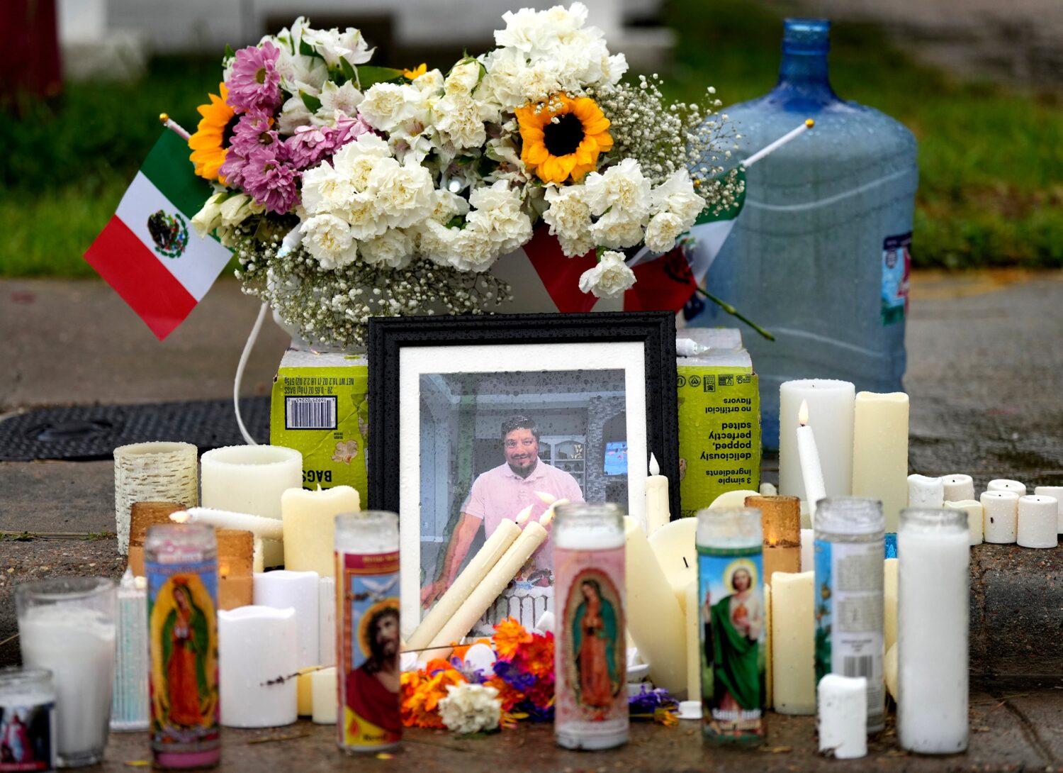 FILE - A memorial grows at the site where Lorenzo Salgado Araujo was fatally shot by ICE agents, la...