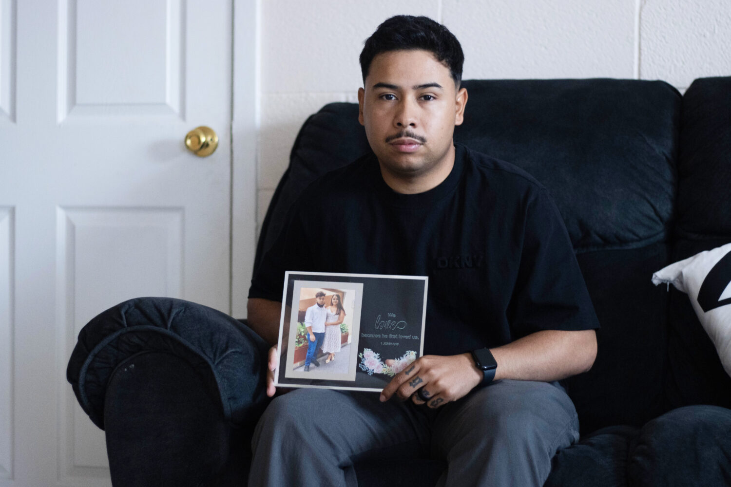 FILE - Army Sgt. Hedar Leonel Turcios Juarez holds a picture of himself with with his wife Cristy a...