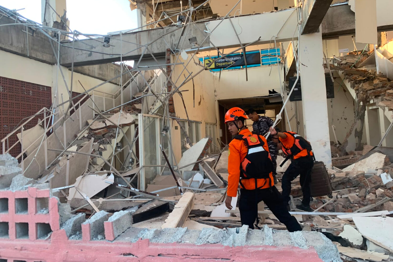 In this photo released by the Indonesian National Search and Rescue Agency (BASARNAS), rescuers sea...
