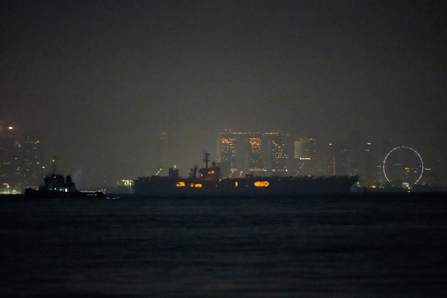 The U.S. Navy aircraft carrier USS Abraham Lincoln sails past Singapore as seen from Batam, Indones...