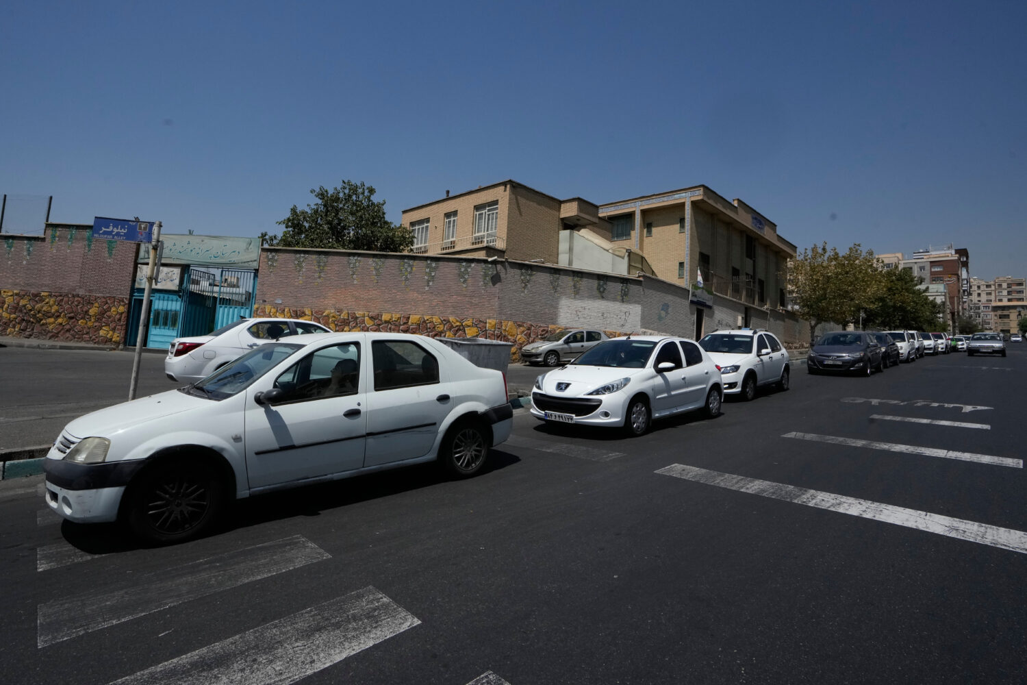 Cars line up outside a gas station in Tehran, Iran, Tuesday, Aug. 25, 2026. (AP Photo/Vahid Salemi)...