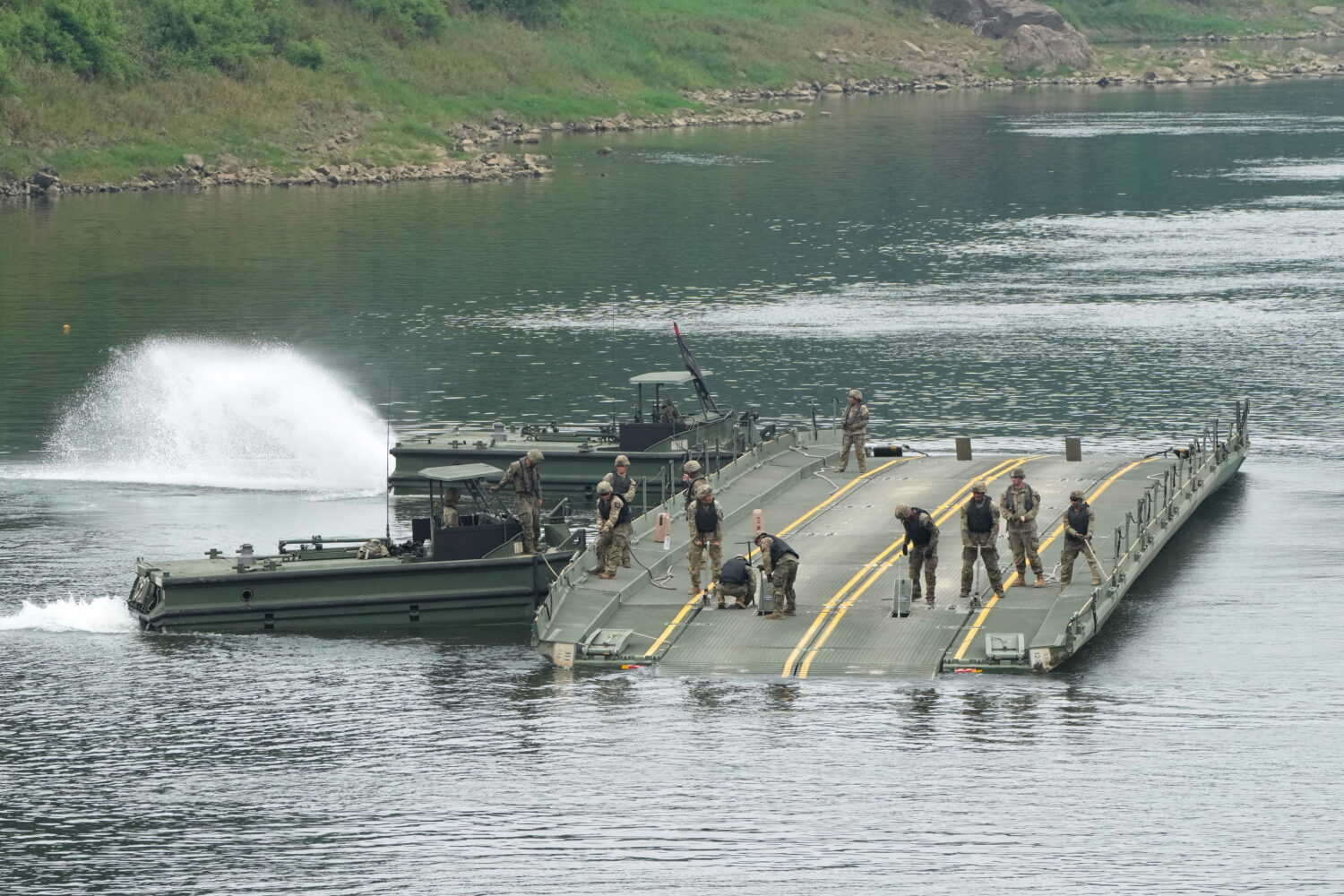 U.S. Army soldiers try to dismantle a floating bridge during a training exercise on a river in Yeon...