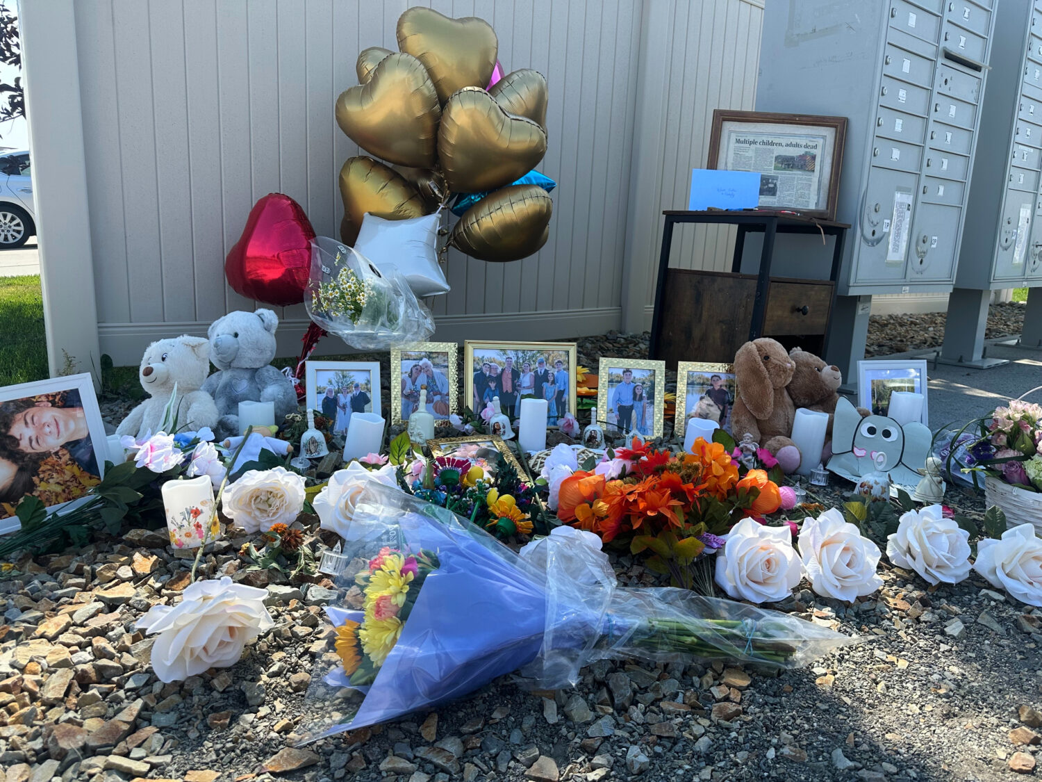 Flowers sit at a memorial honoring eight family members who were killed while gathering for dinner ...