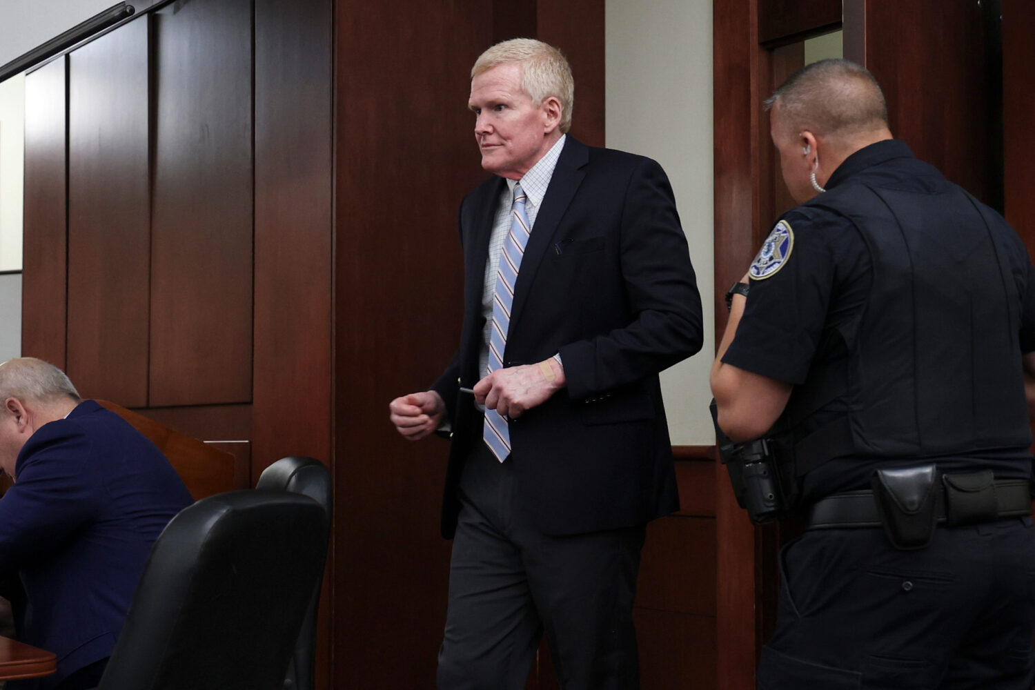 Alex Murdaugh, dressed in street clothing, enters the courtroom for a hearing Friday, Aug. 14, 2026...