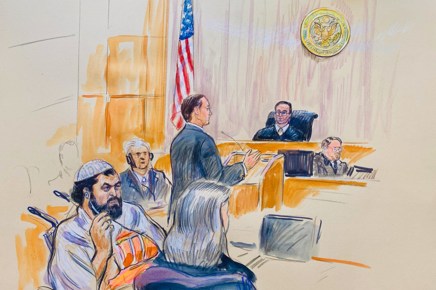 This courtroom sketch depicts Rahmanullah Lakanwal, 29, seated left, with defense attorney Michelle...