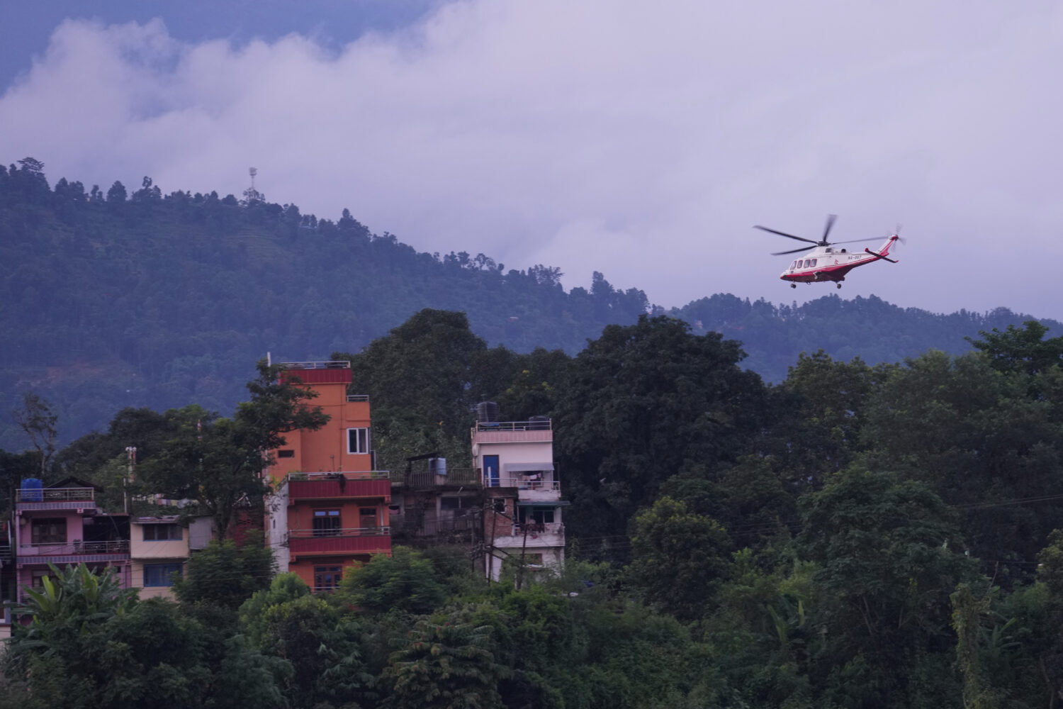 A government helicopter conducts a rescue mission amidst the devastation left by flash flooding in ...