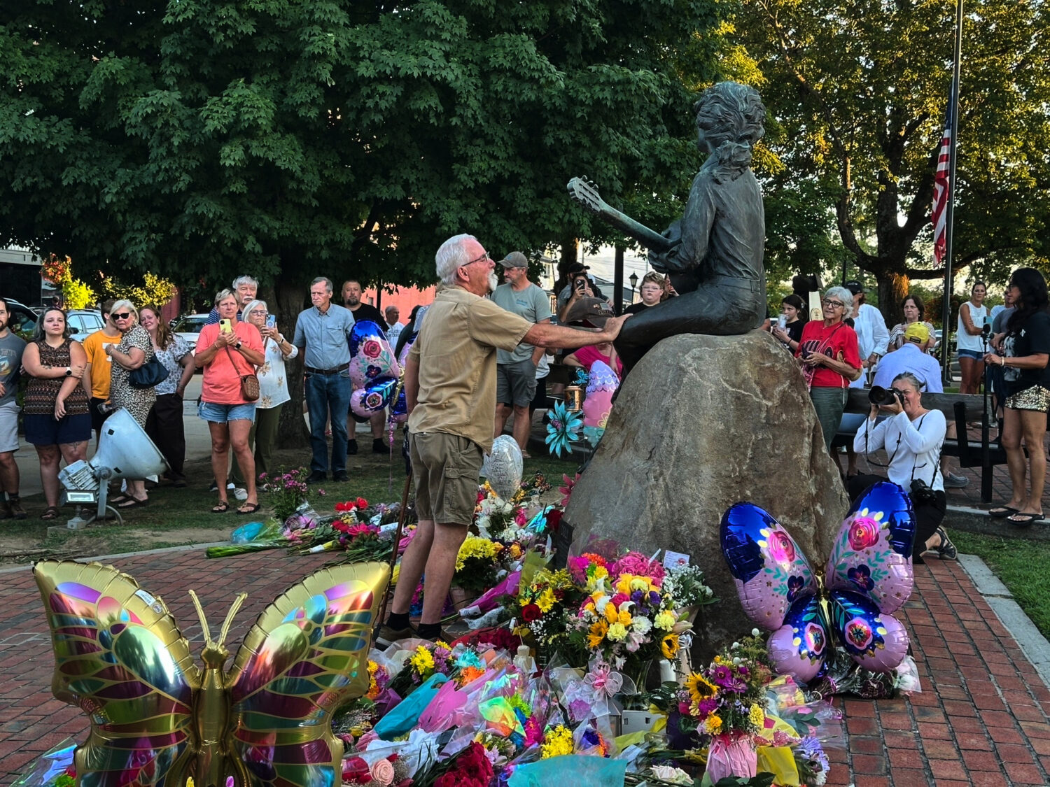 James A. Gambrell, a former chef at Dollywood, touches the Dolly Parton statue in downtown Seviervi...