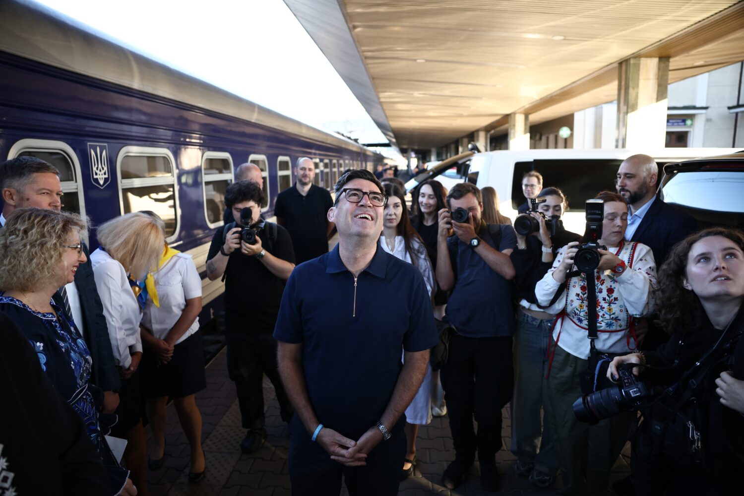 Britain's prime minister Andy Burnham, centre, smiles upon his arrival by train, in Kyiv, Monday, A...