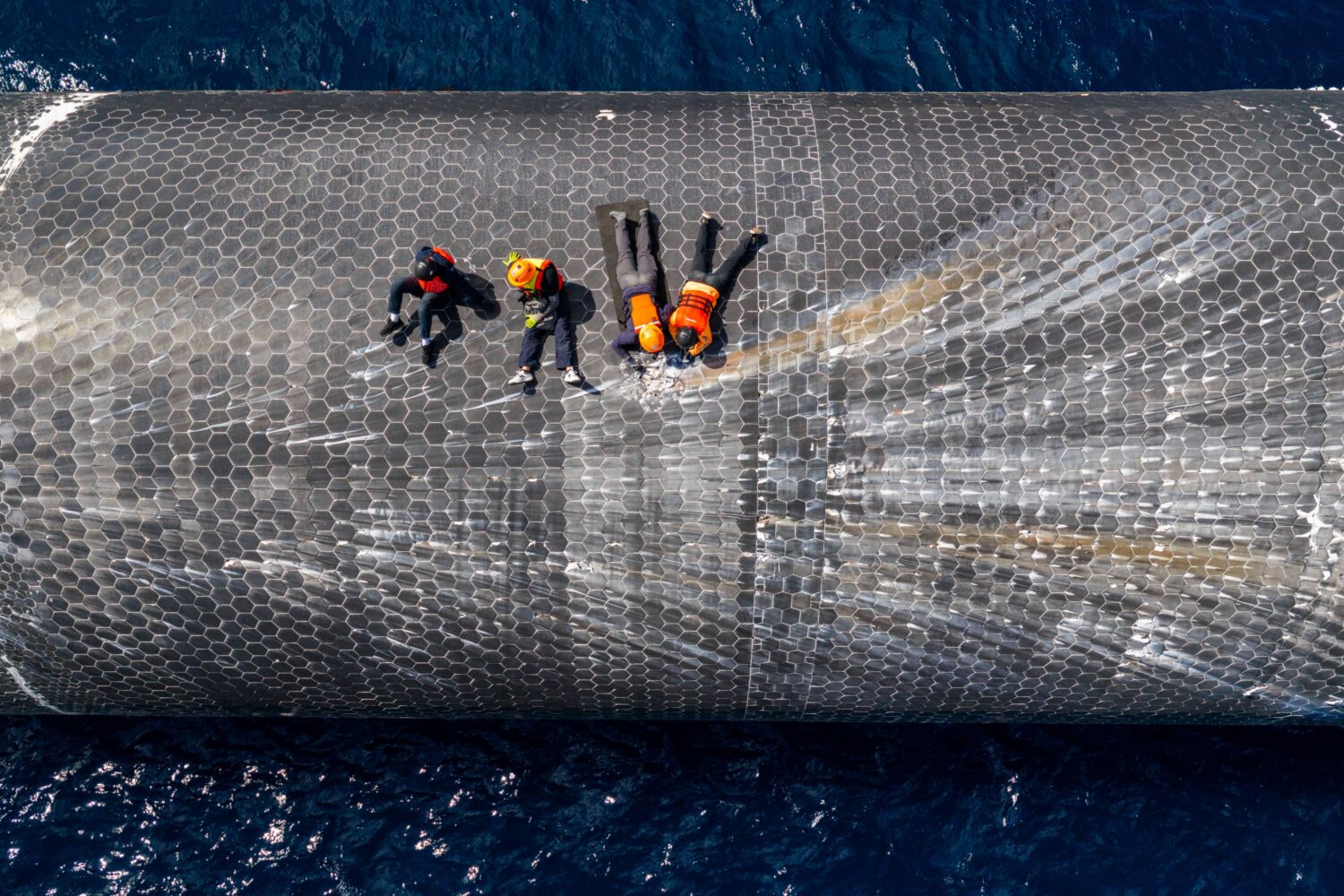 This image provided by SpaceX on Aug. 27, 2026, shows engineers inspecting Starship off the coast o...